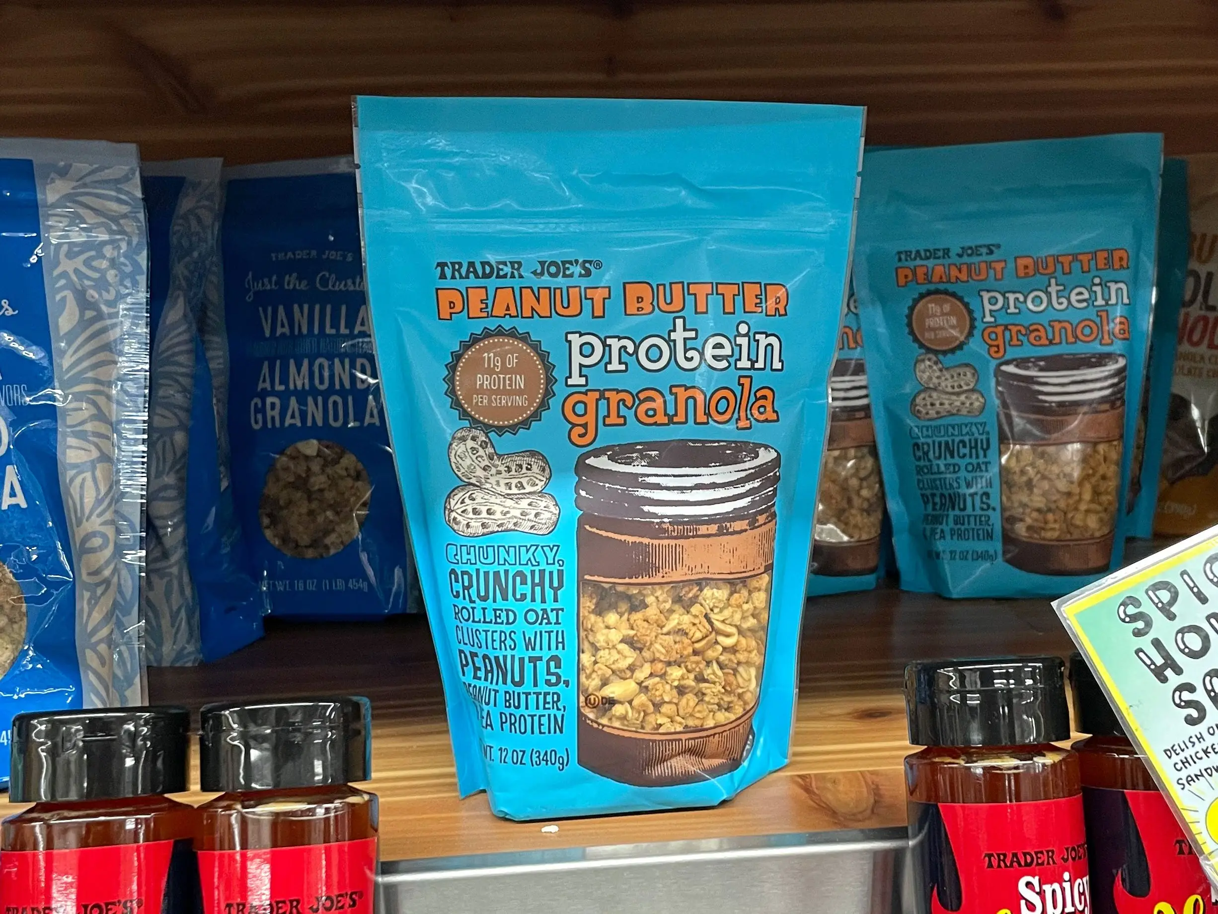 Packages of Trader Joe's peanut-butter-protein granola on a shelf.