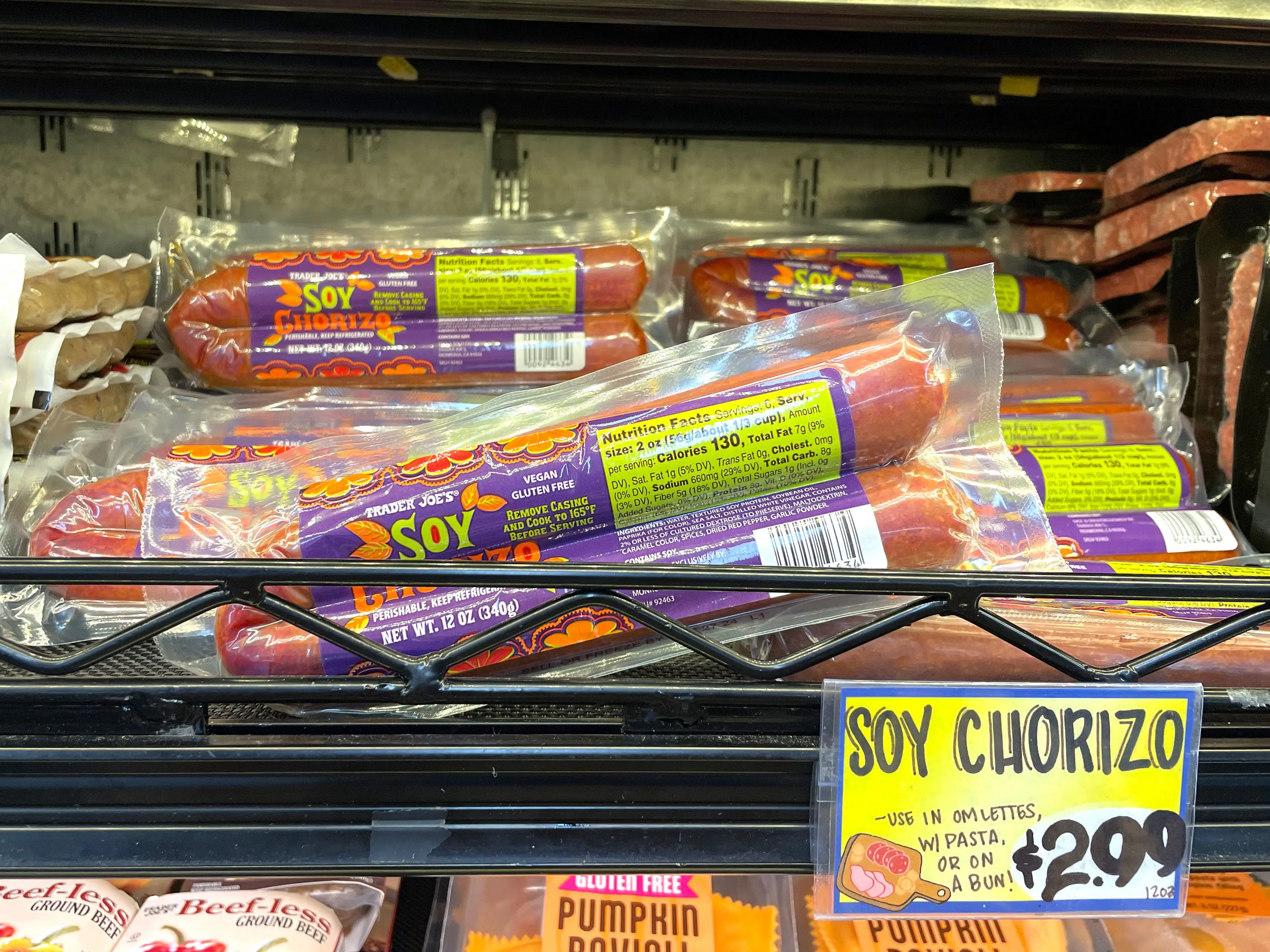 Packages of Trader Joe's soy chorizo on a shelf, with a sign that reads $2.99.