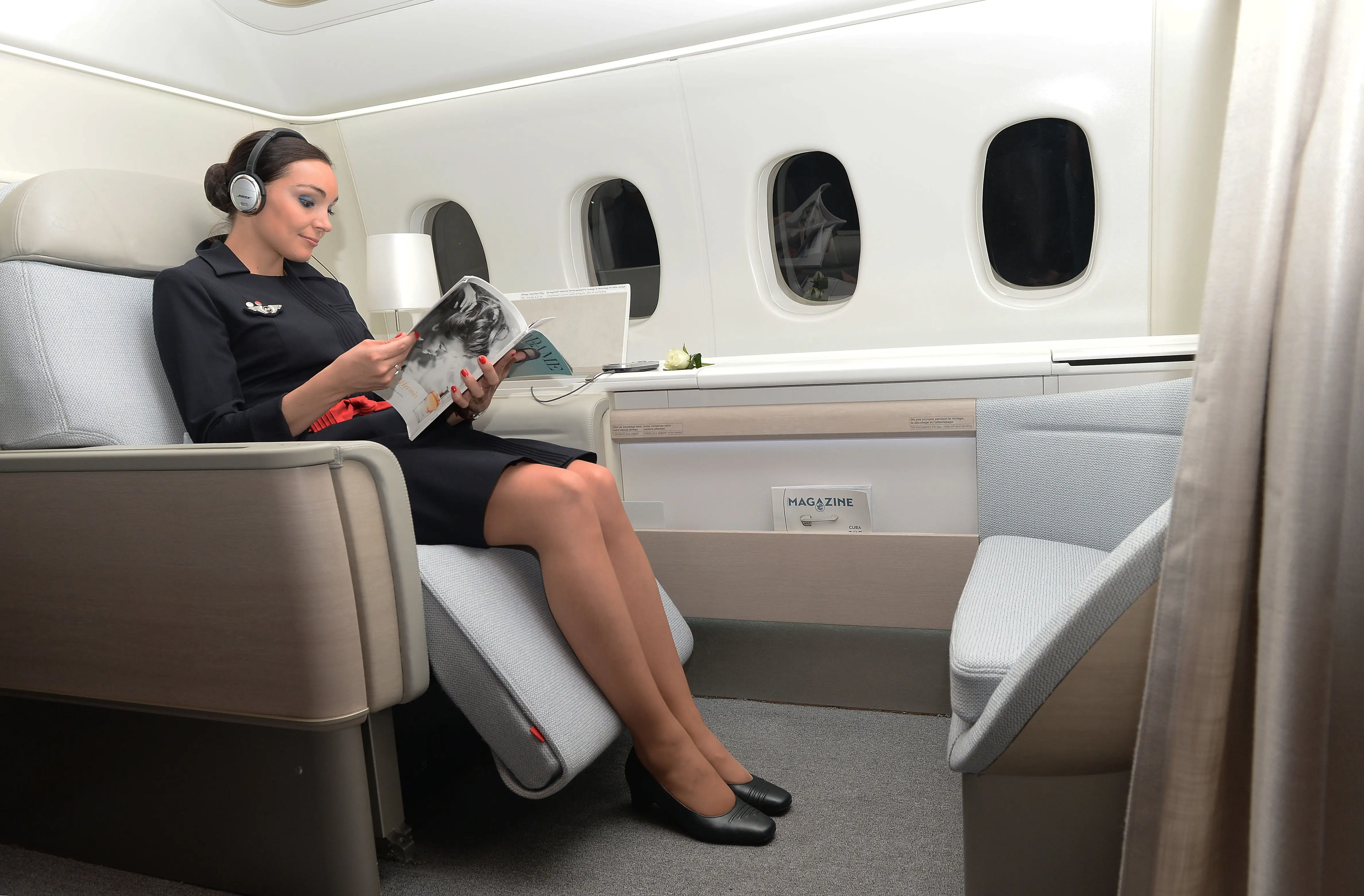 flight attendant sitting in air france first class.