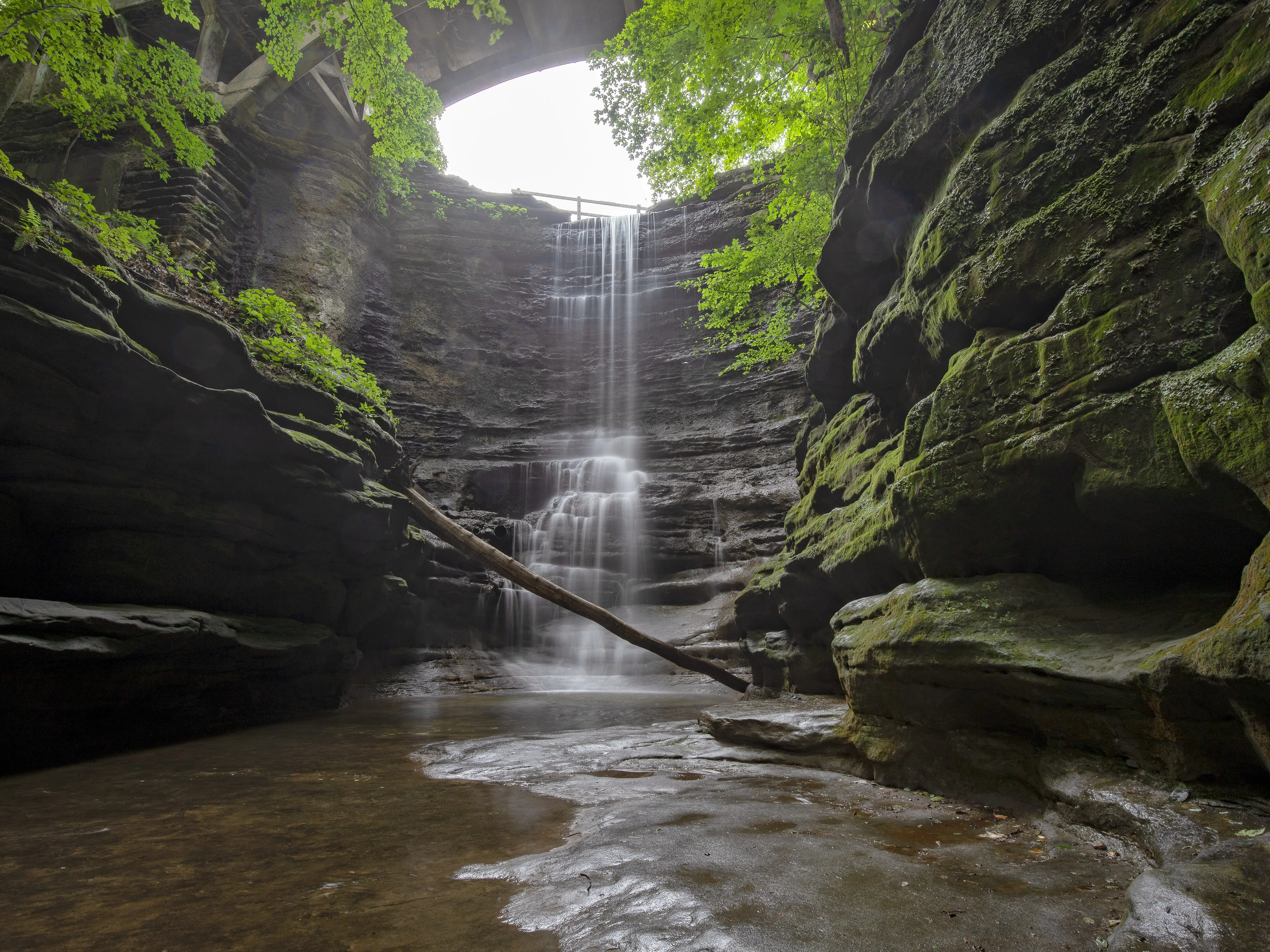 A waterfall in a canyon covered in moss.