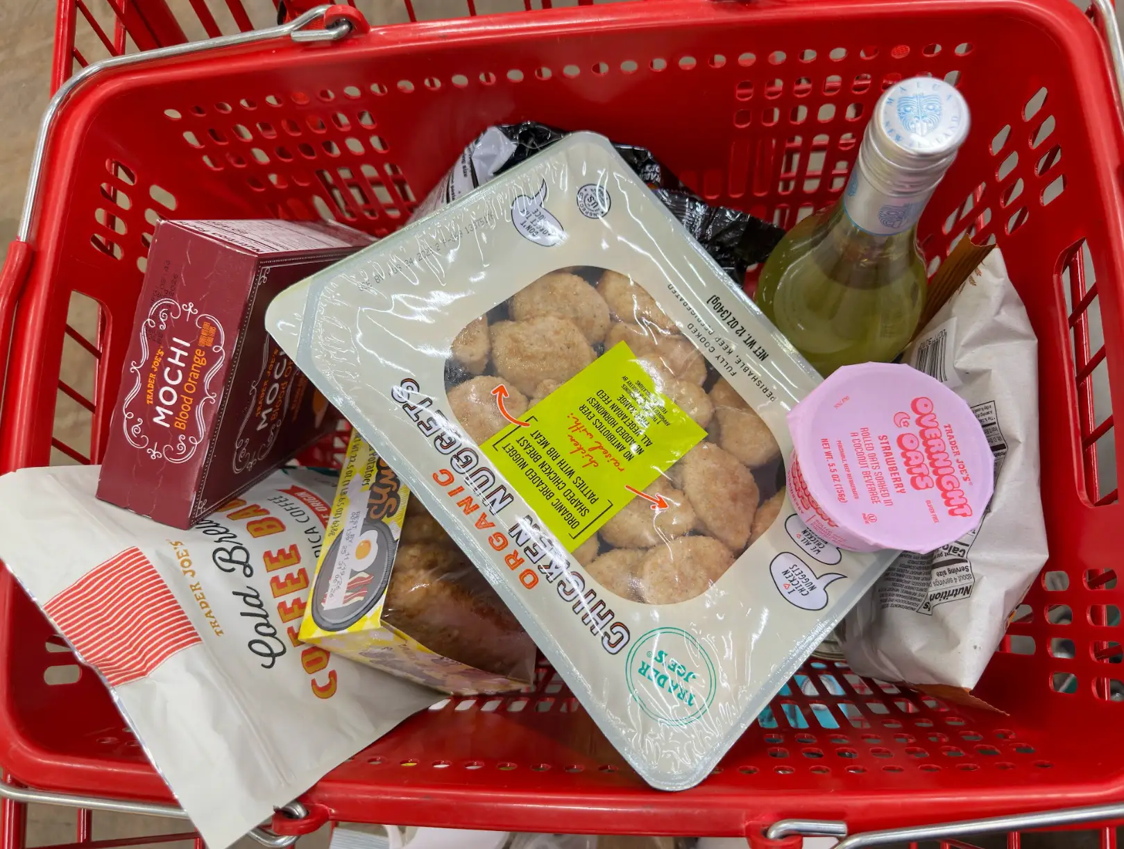 The writer's Trader Joe's cart, including chicken nuggets and overnight oats.