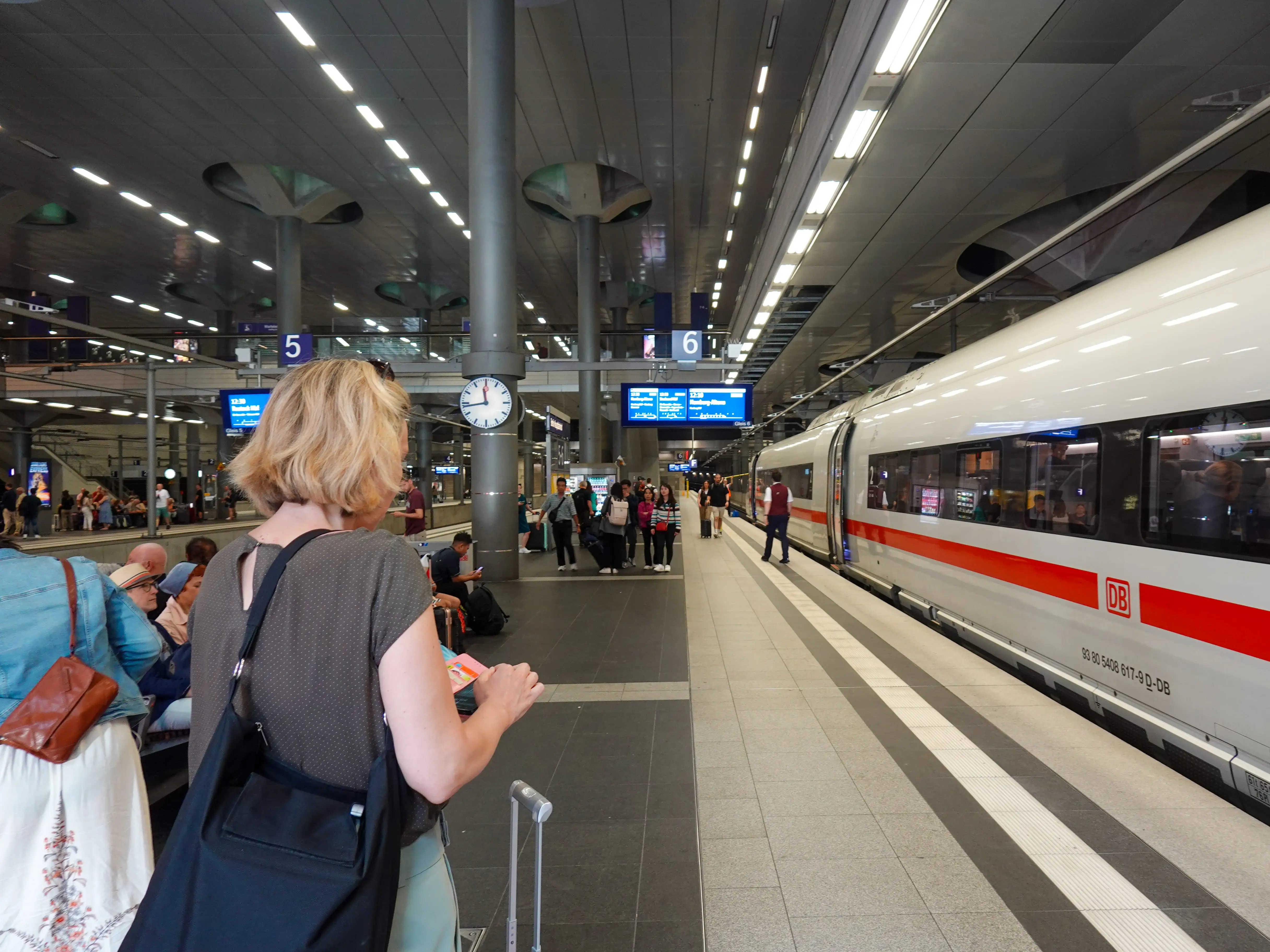Passengers wait for an ICE long-distance train of Deutsche Bahn at Berlin Hauptbahnhof train station