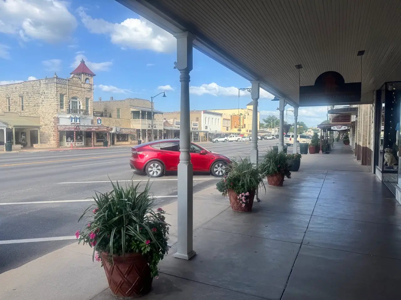 Main street area with empty parking spots, plants