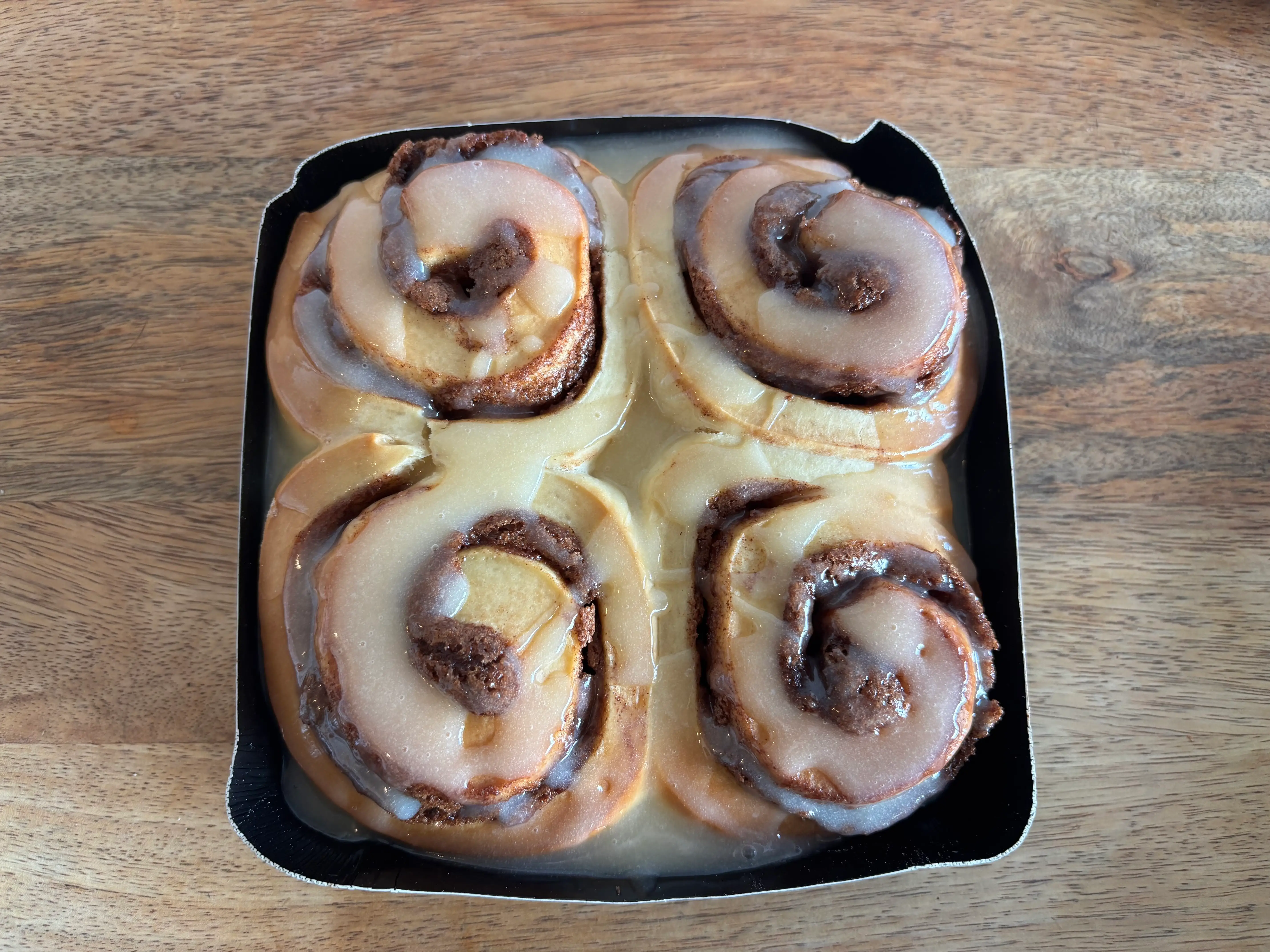 Four cinnamon rolls in a bakeable tray.