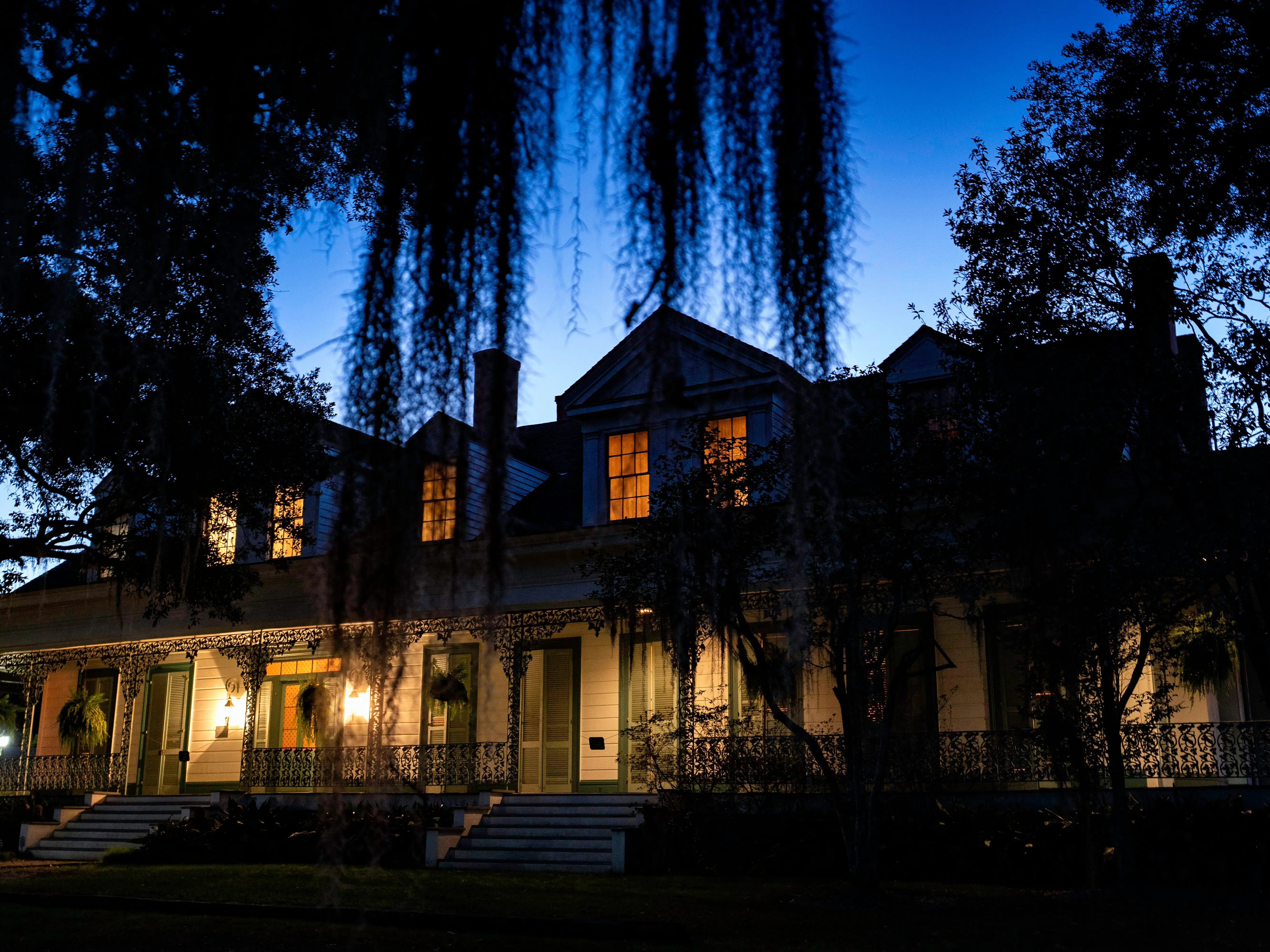 Spanish moss hanging from Crepe Myrtle trees at night outisde the Myrtles Plantation in St. Francisville.
