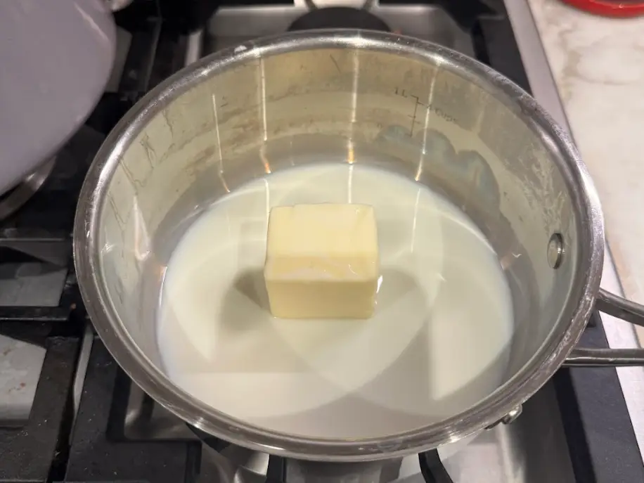 Butter and milk melting on the stovetop.