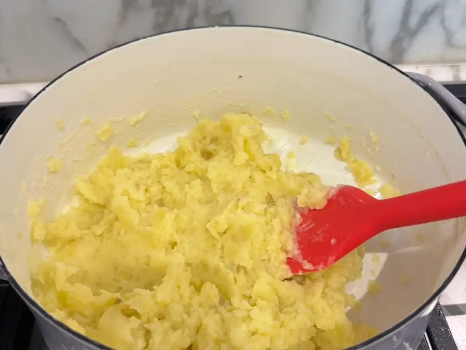 Mashing Ina Garten's mashed potatoes.