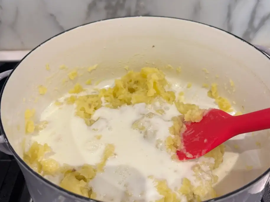 The writer mixing buttermilk into her mashed potatoes.