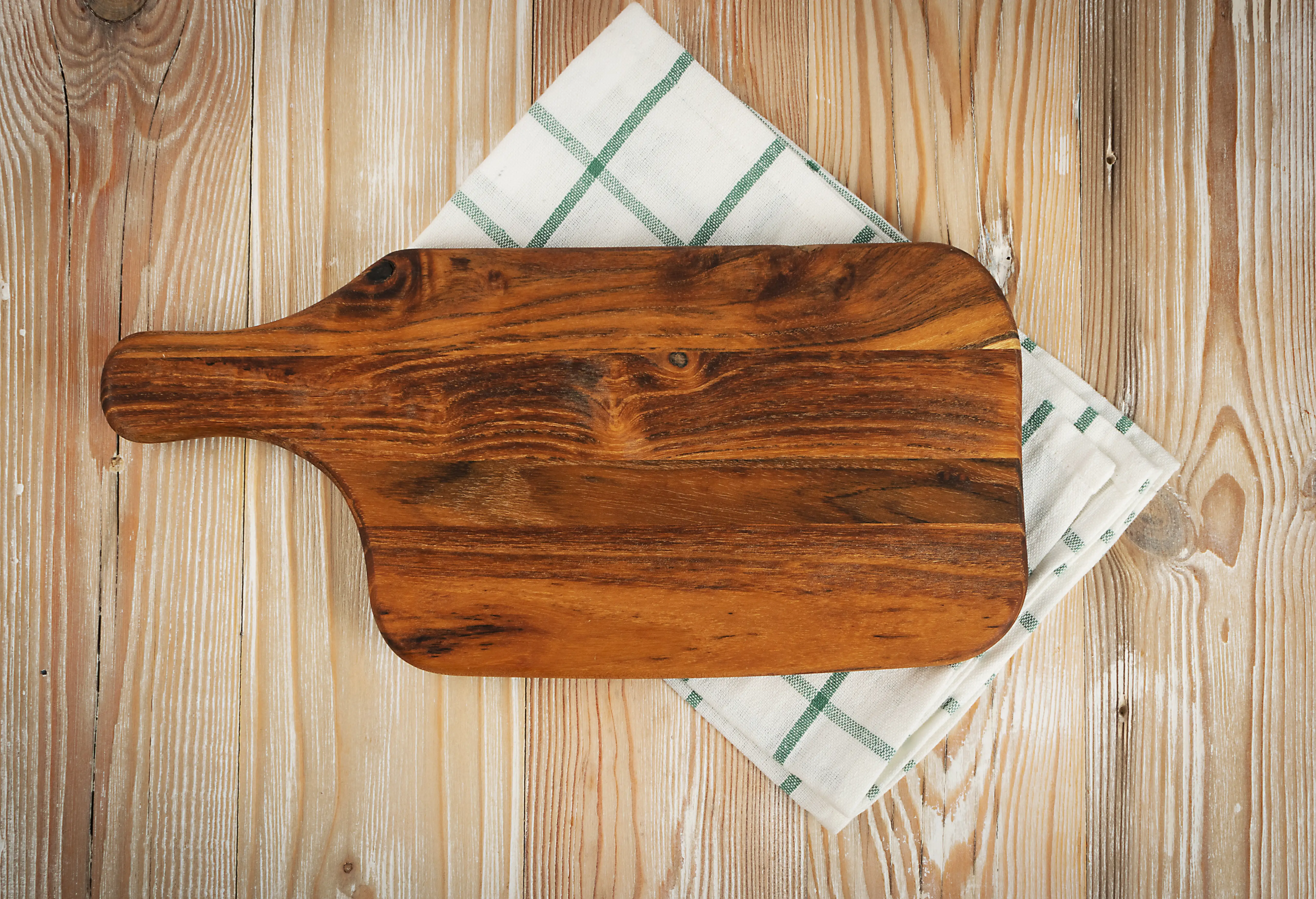Cutting board with kitchen towel under it
