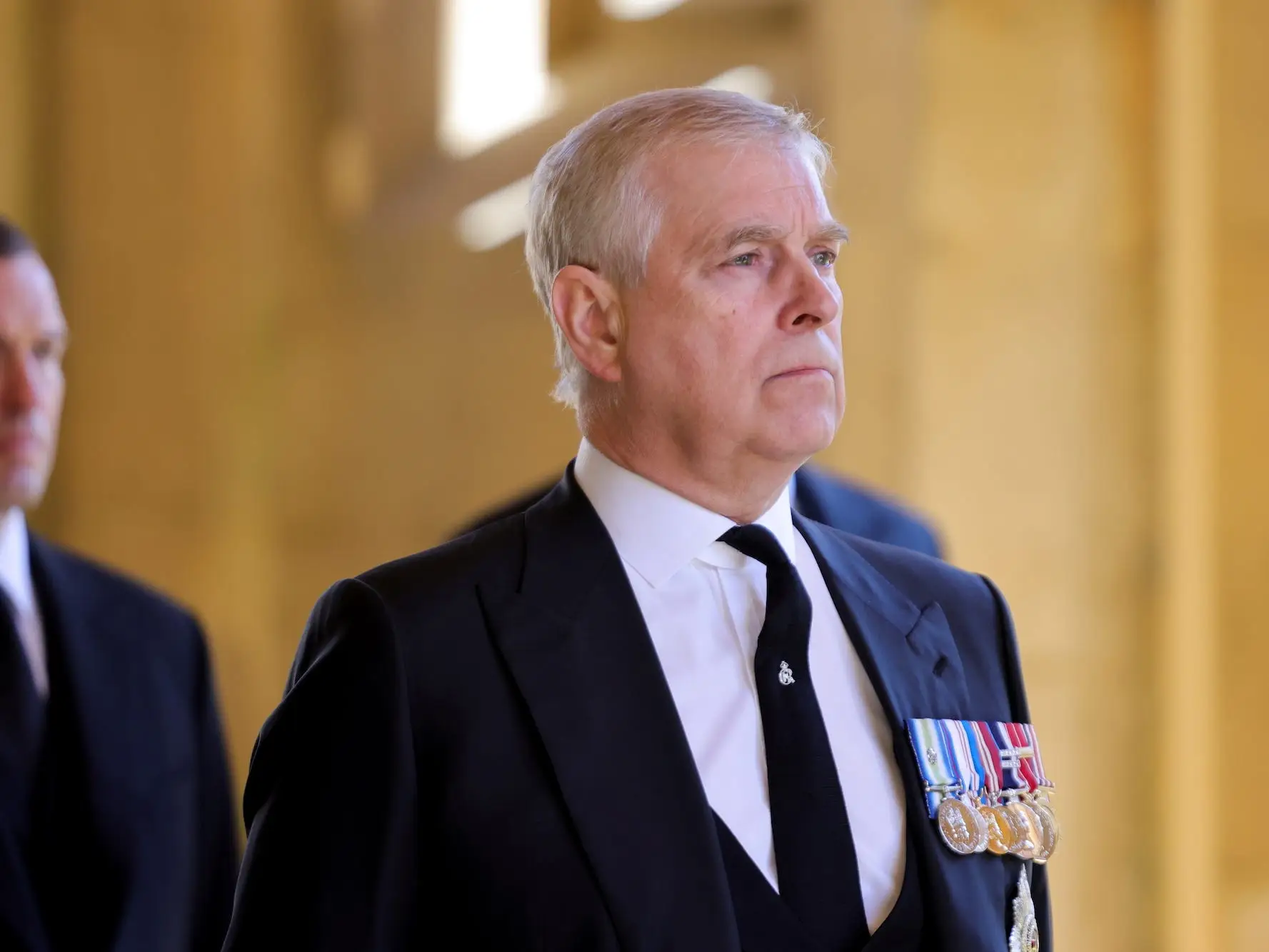 Prince Andrew wearing a dark suit and medals at Prince Philip's funeral in April 2021.