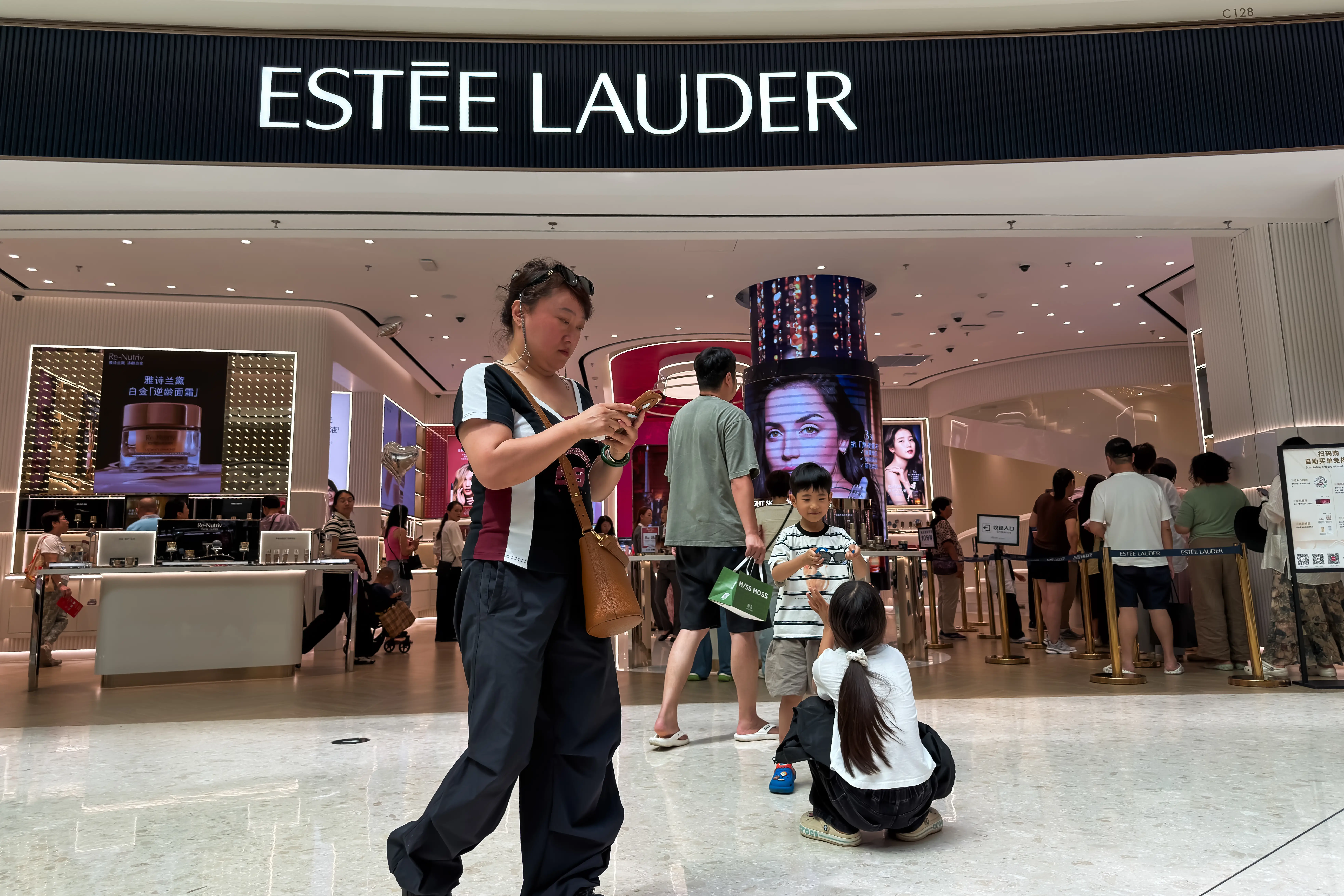 Shoppers gather at an Estée Lauder store at the Sanya International Duty Free Shopping Complex, also known as CDF Mall, on March 5, 2026 in Sanya, Hainan Province, China.
