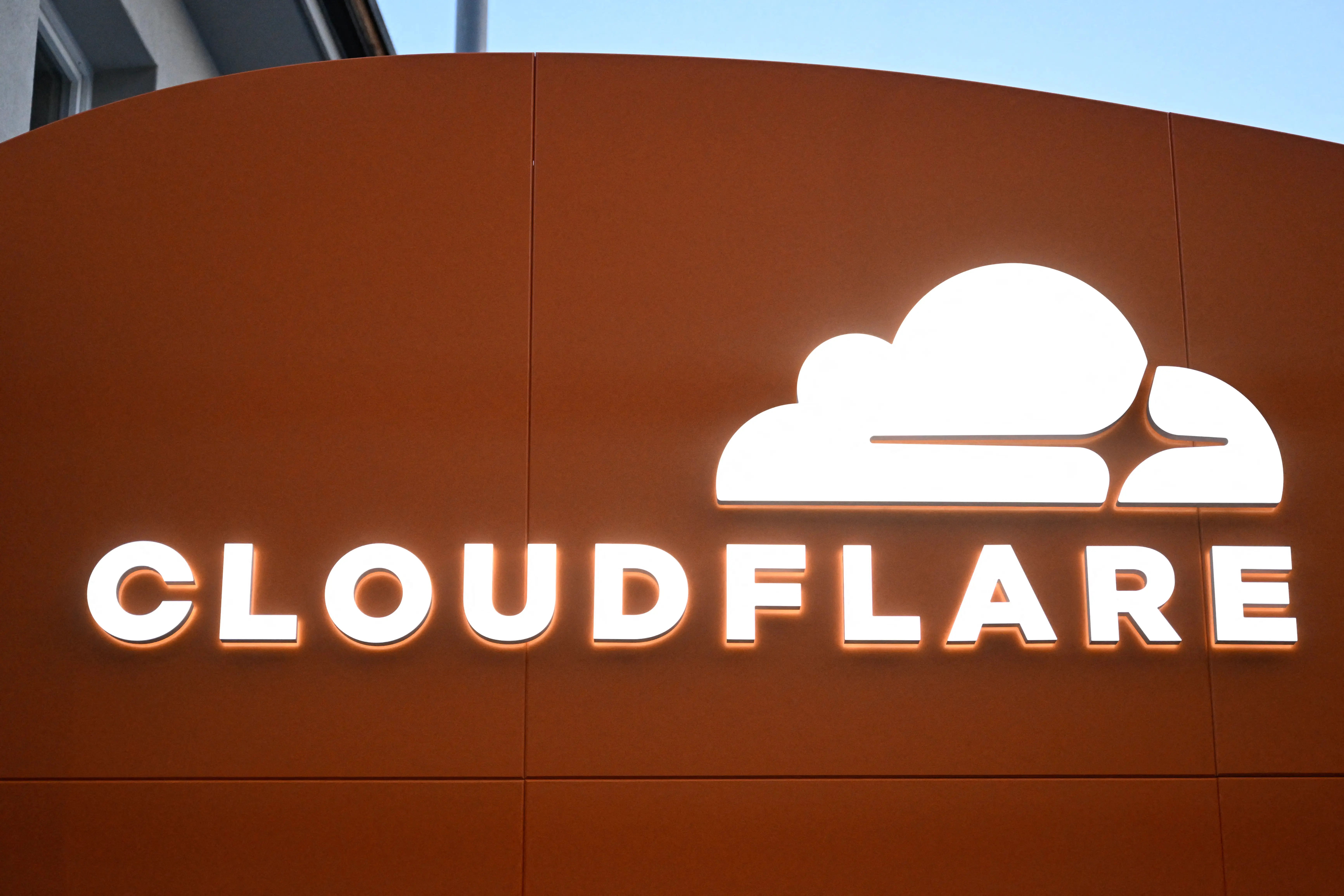 This photograph taken on January 21, 2026 shows signage of the Cloudflare logo during the World Economic Forum (WEF) annual meeting in Davos. The World Economic Forum takes place in Davos from January 19 to January 23, 2026. (Photo by INA FASSBENDER / AFP via Getty Images)