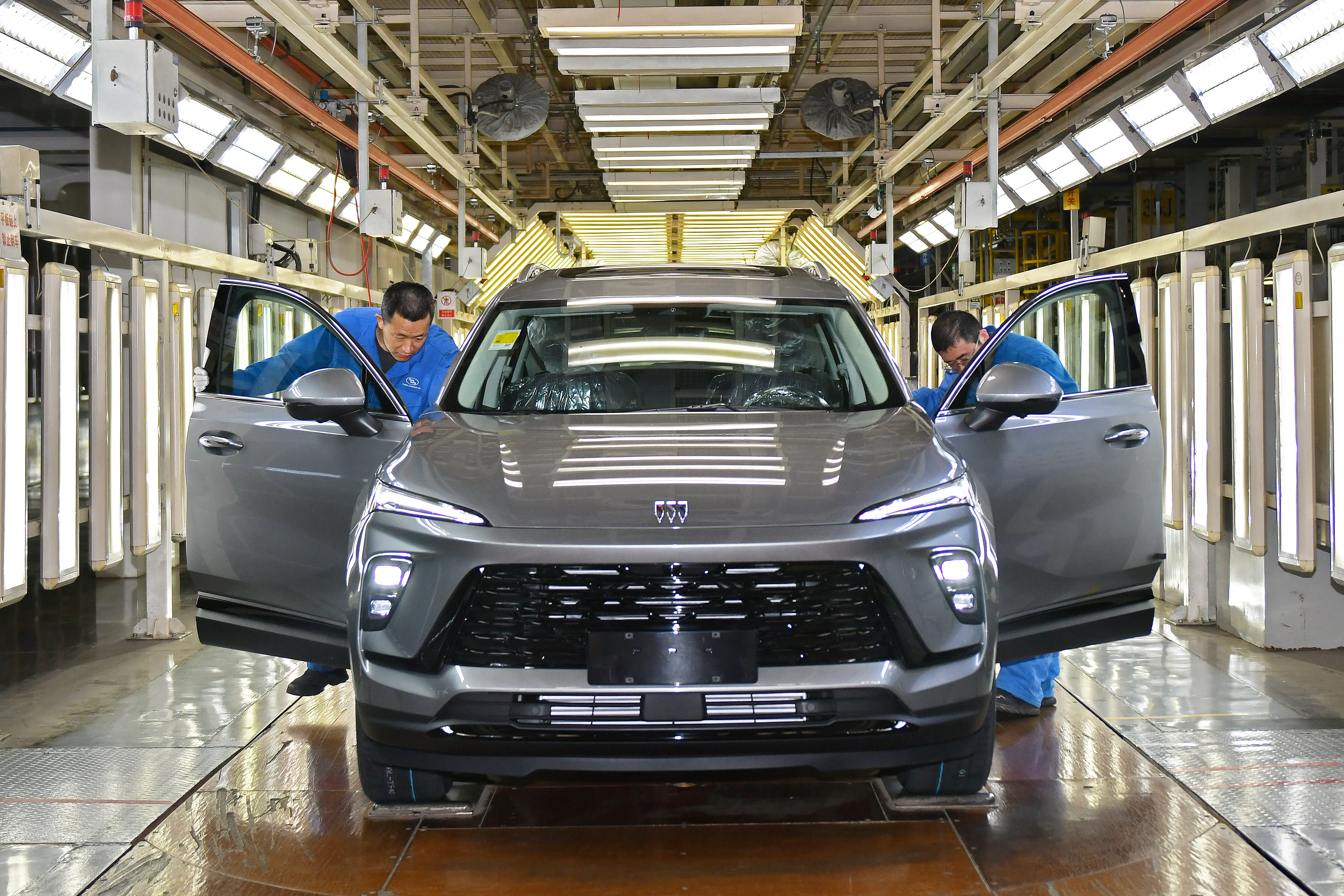 Workers in the automobile assembly production line at SAIC General Motors Dongyue Base in HuangBohai New Area in Yantai, Shandong, China in April 2026