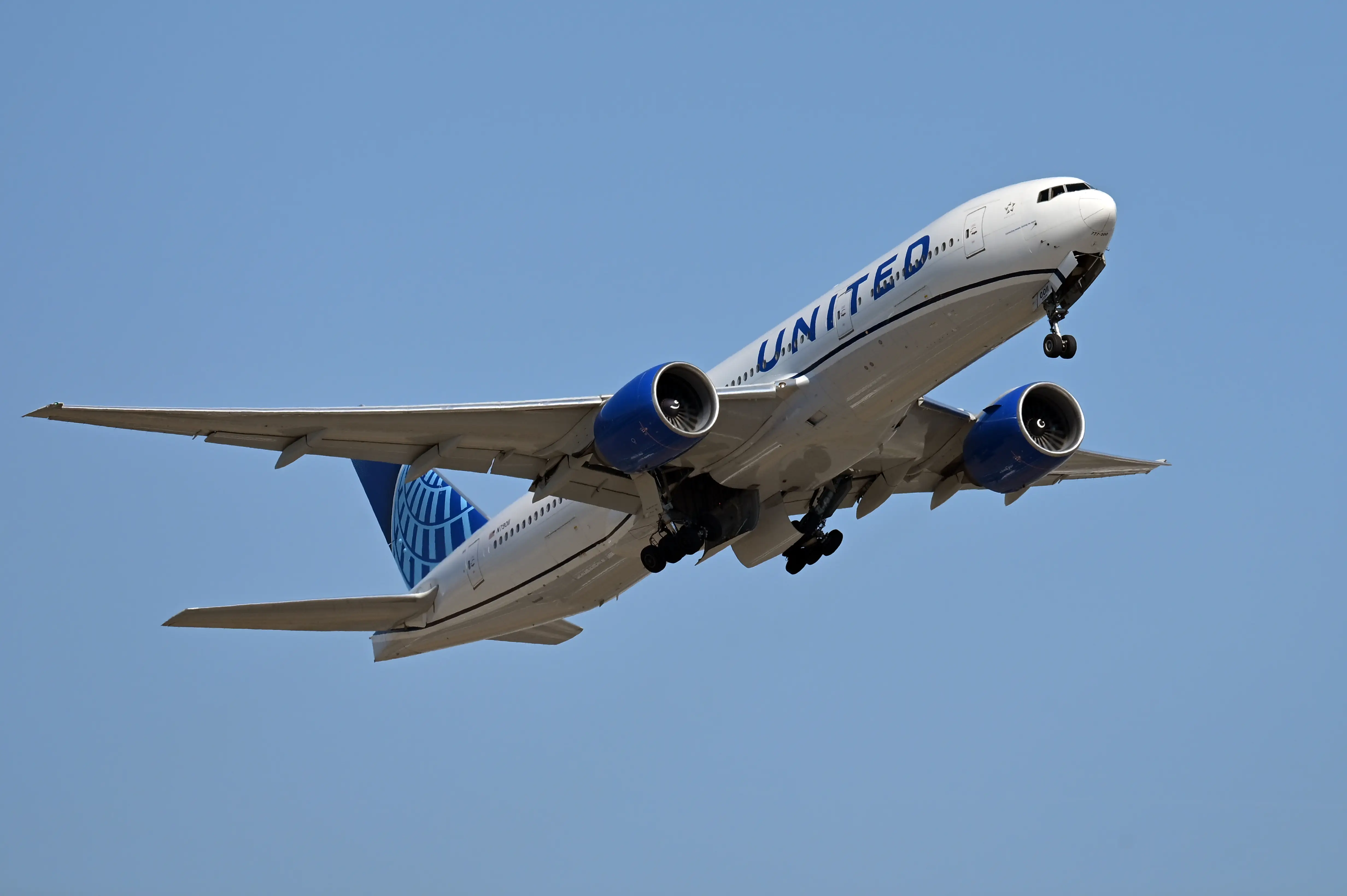 A United Airlines plane in the sky during a flight.