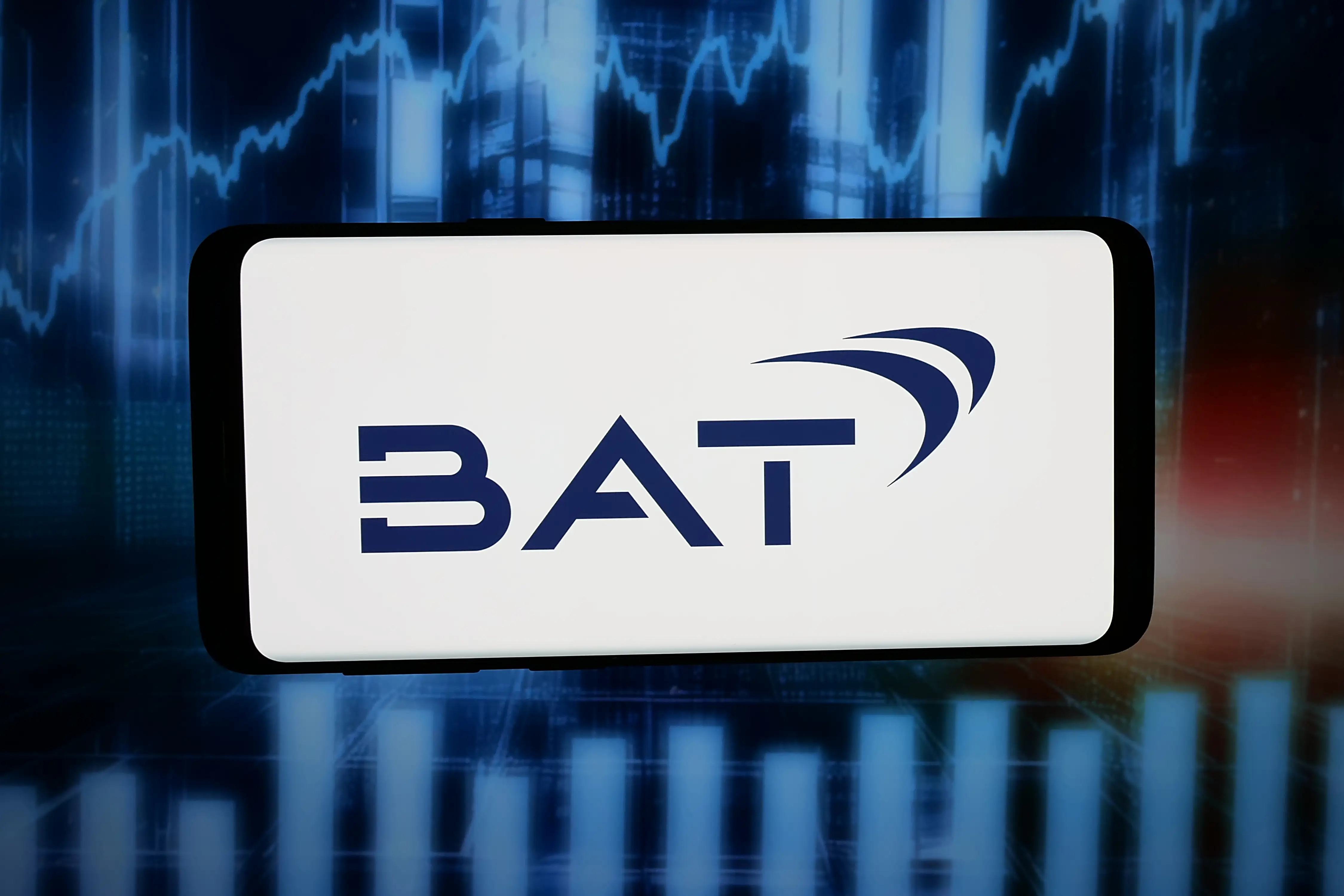 The logo of company British American Tobacco is displayed on a smartphone in front of abstract background on tablet screen.