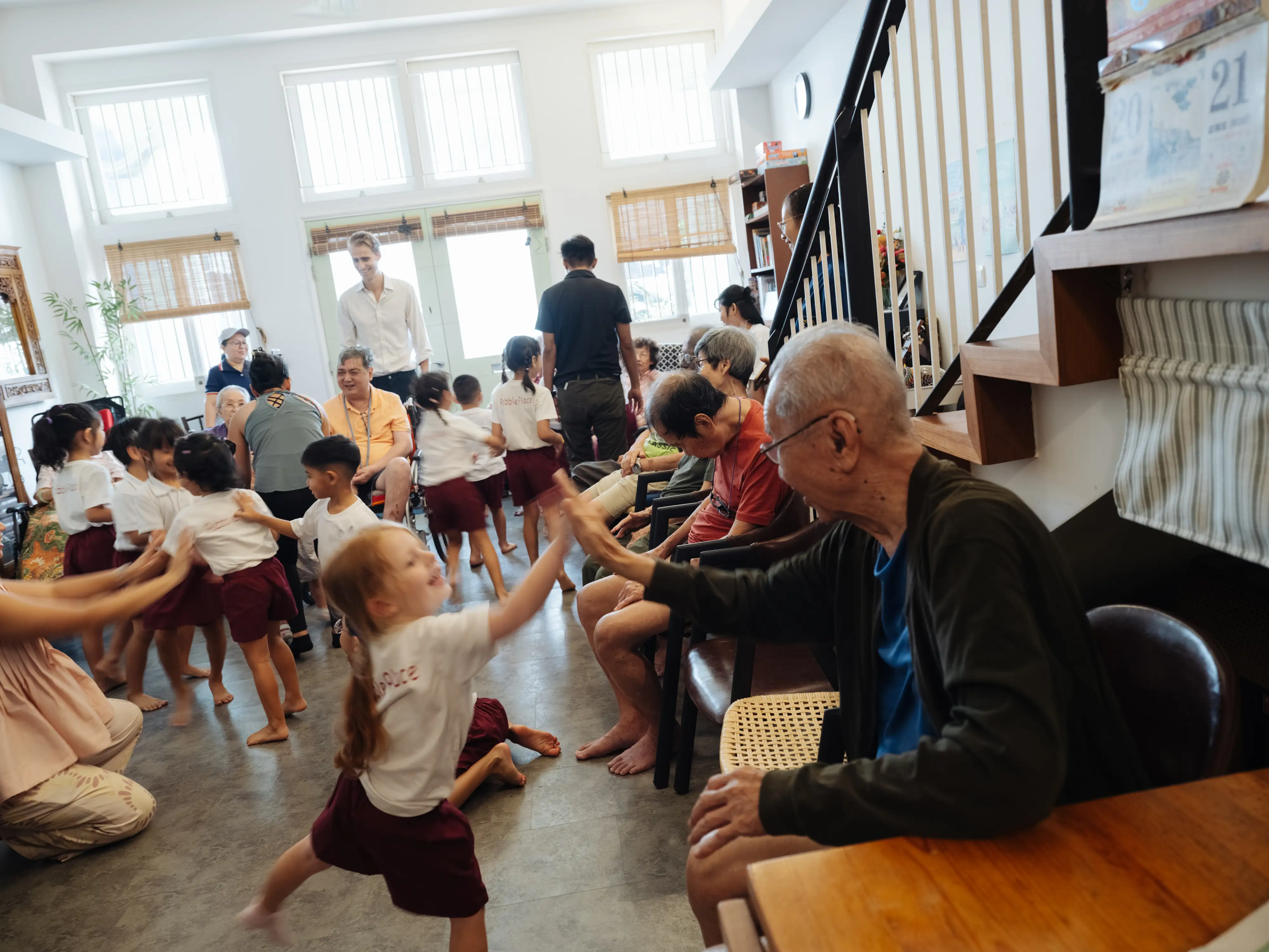 A kid giving an older adult a high five.
