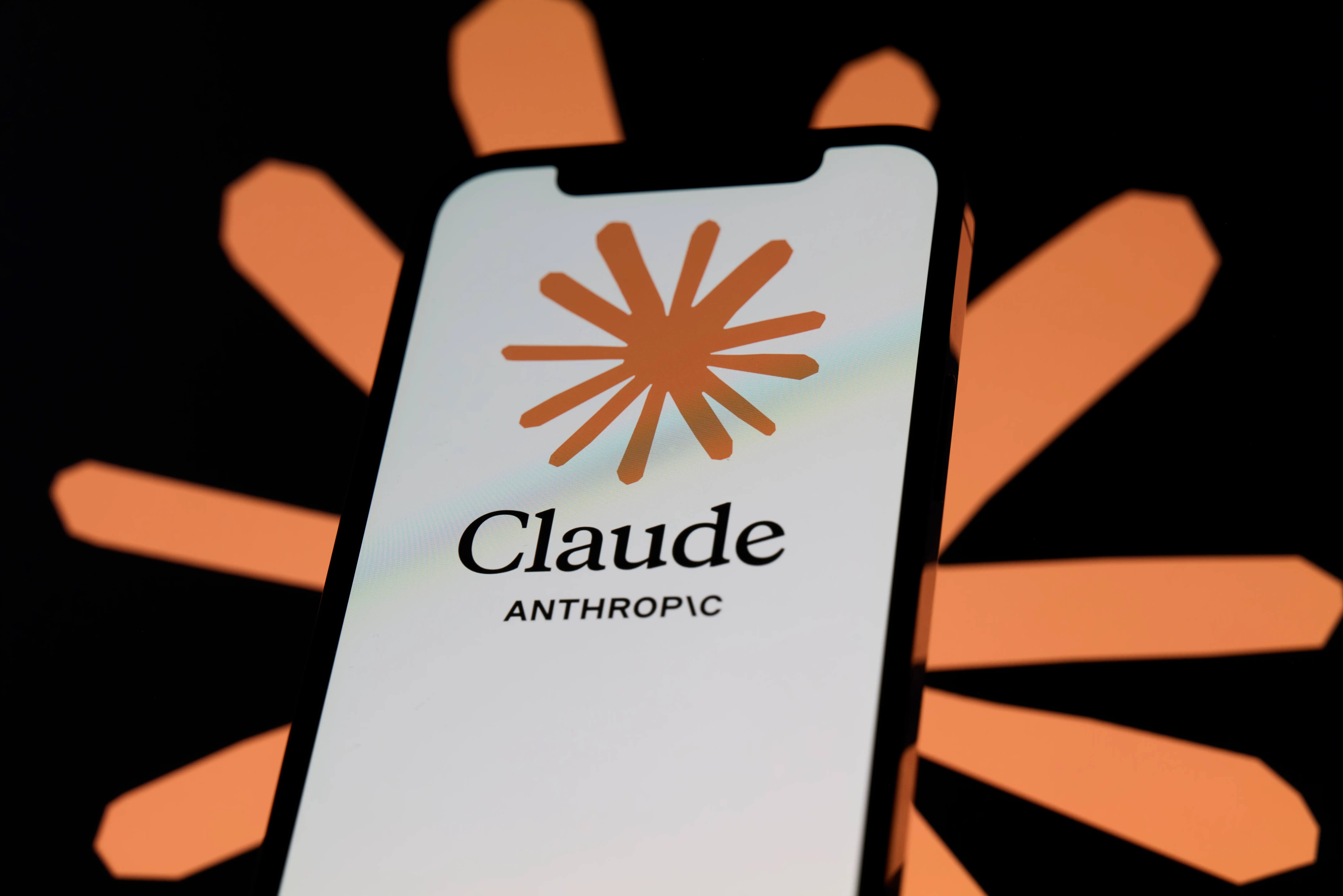 A picture showing the Claude logo on a smartphone.