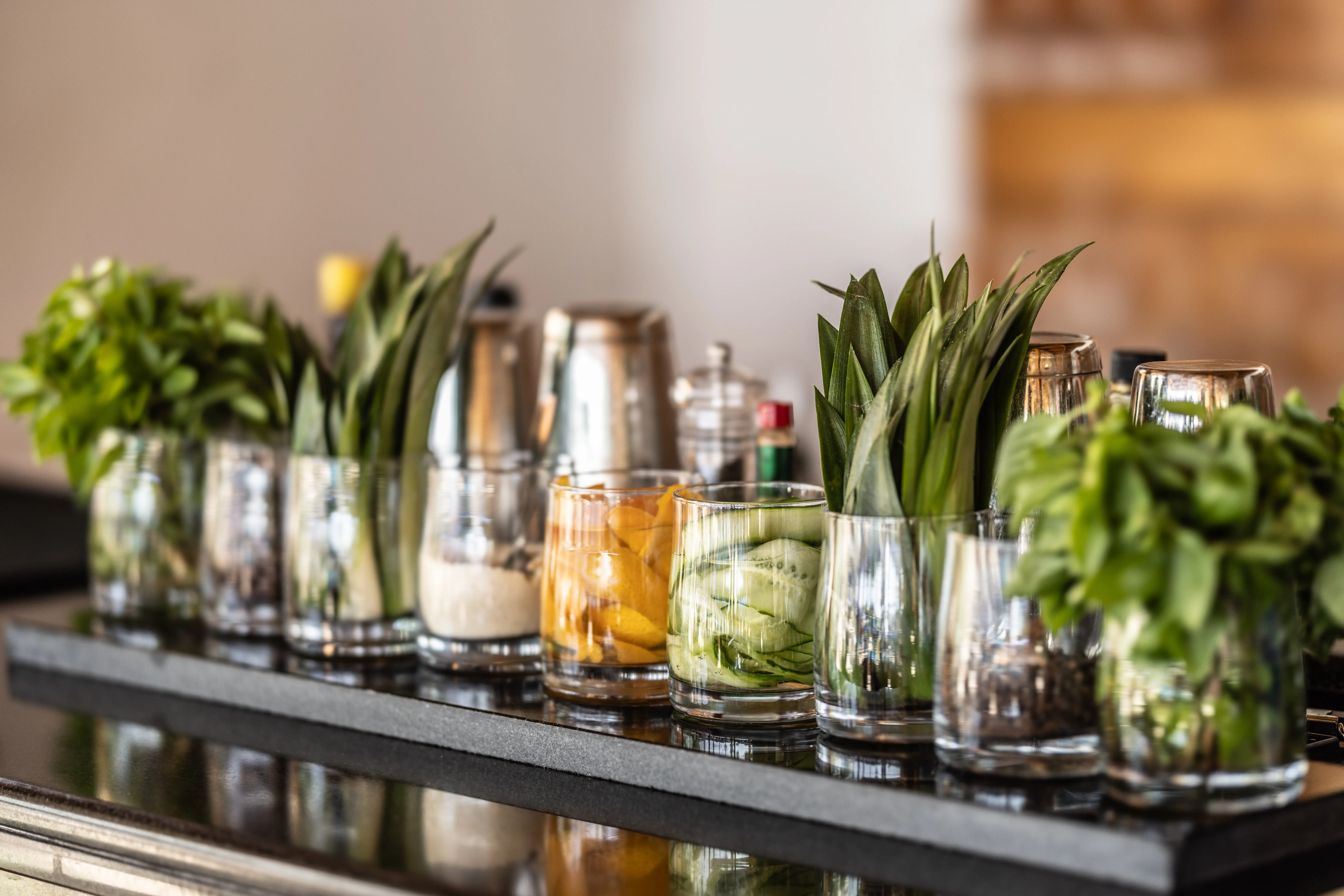Bar counter setup with ingredients for mixed drinks