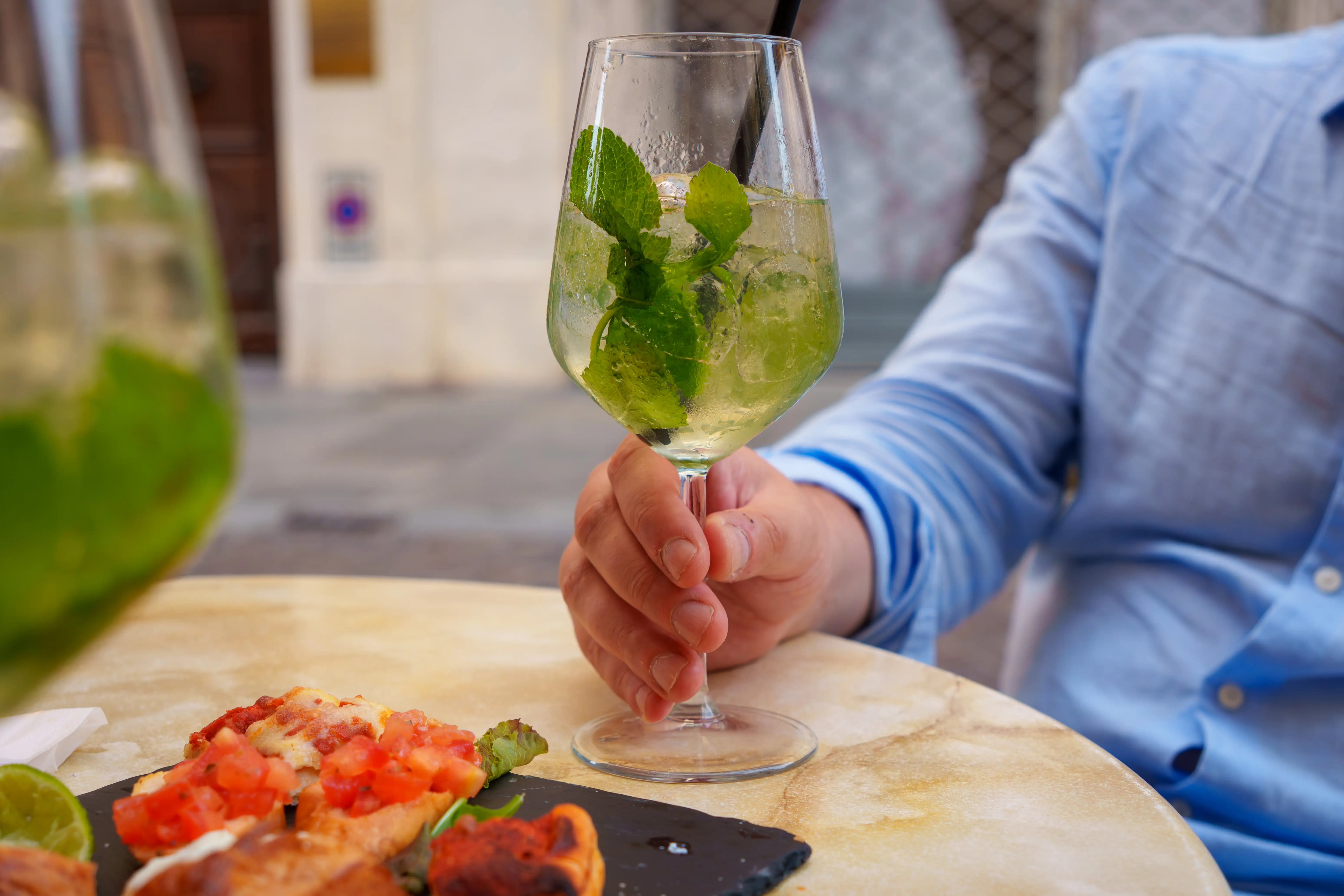 Hand holding Hugo spritz