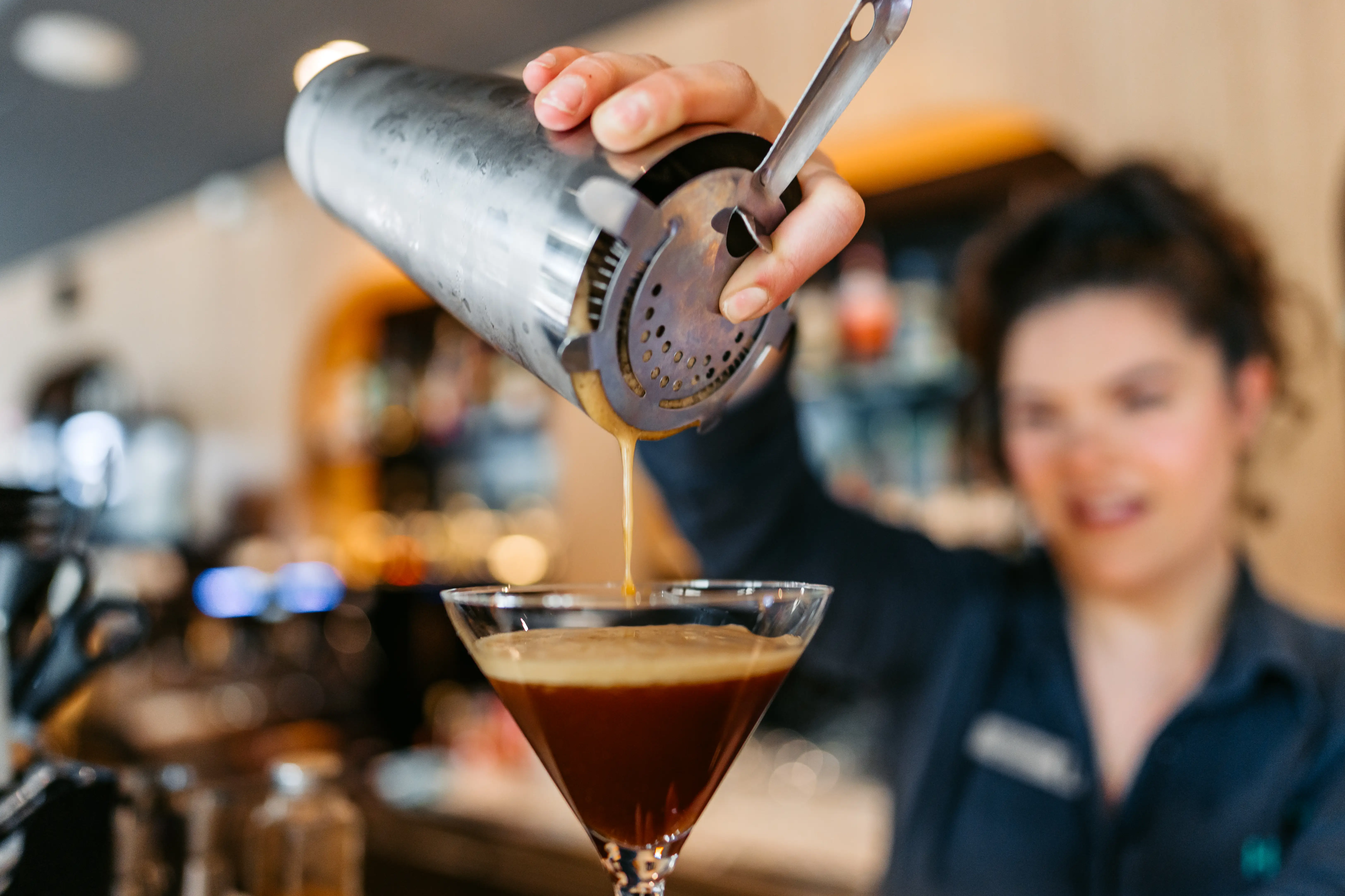 bartender pouring espresso martini