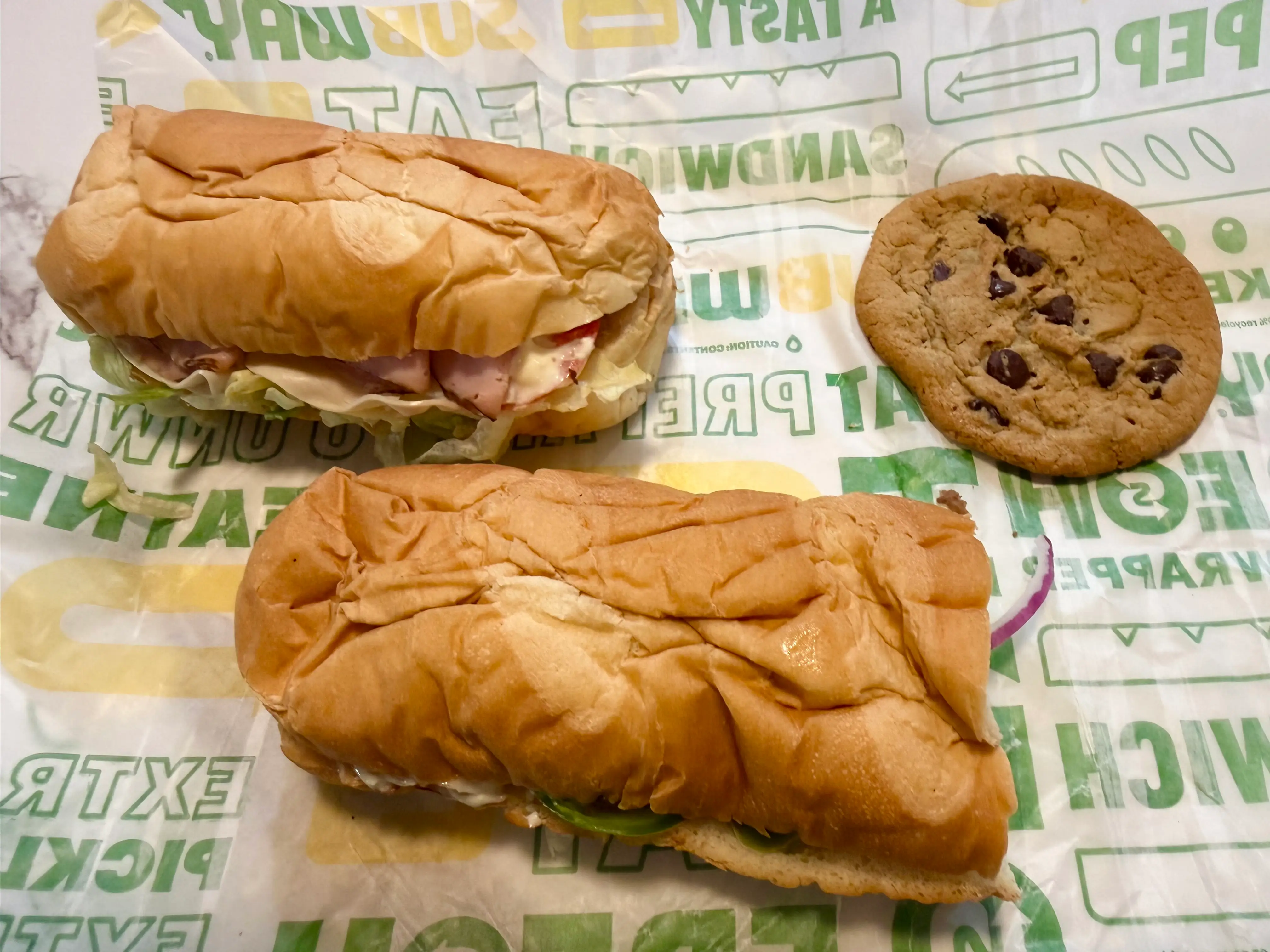 two sandwiches and a cookie from Subway