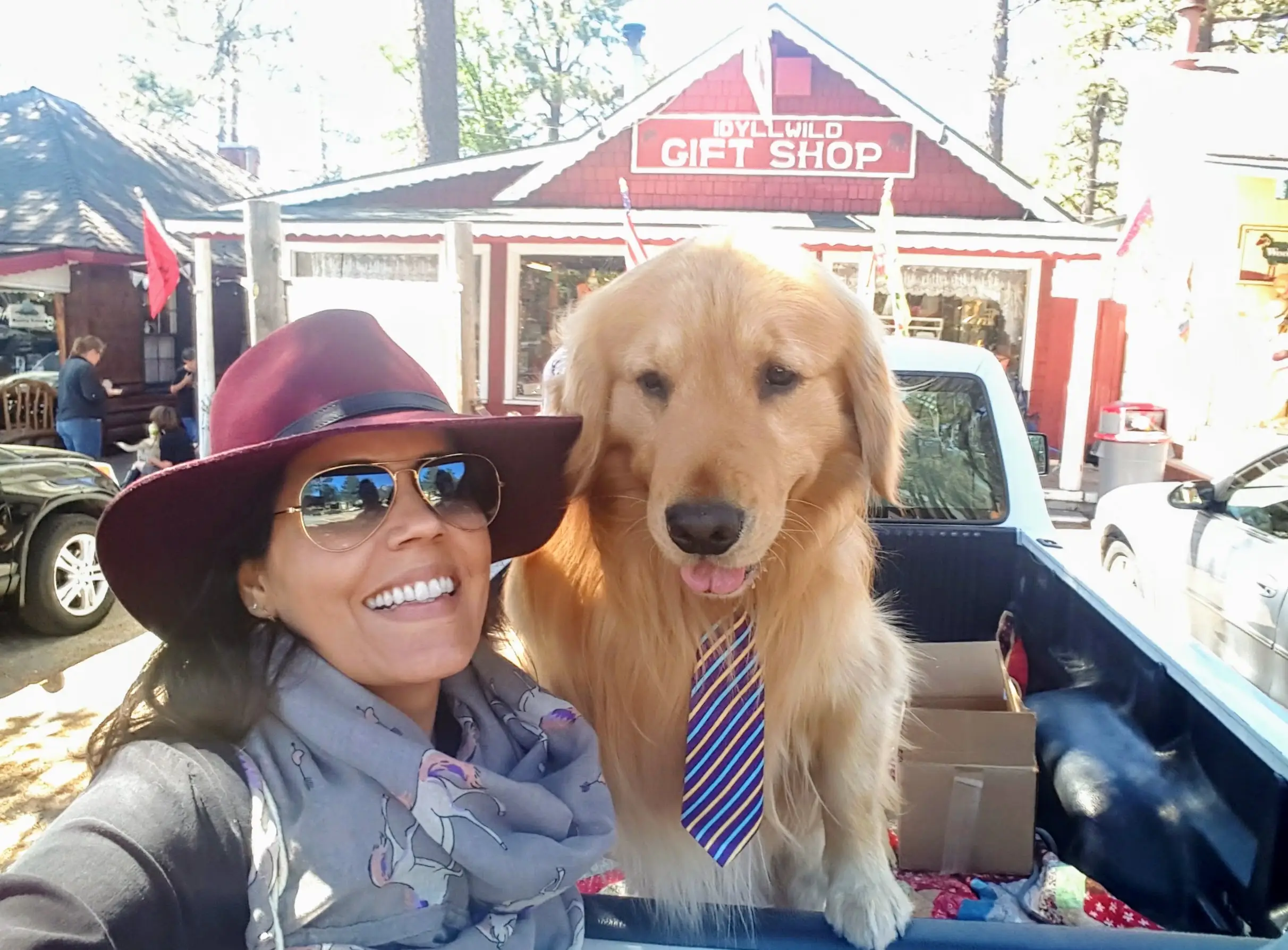 Woman smiling with dog wearing a tie