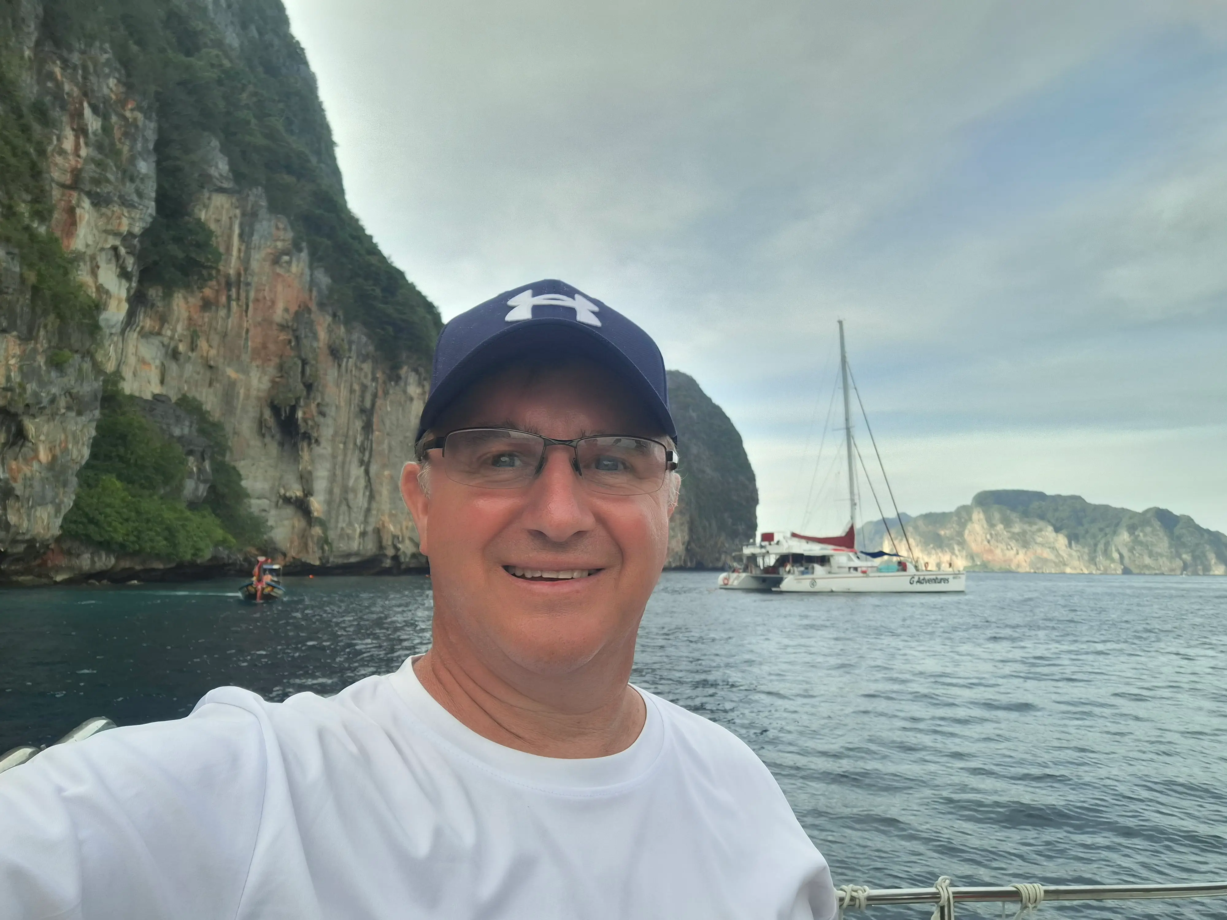 A man taking a selfie at the beach.