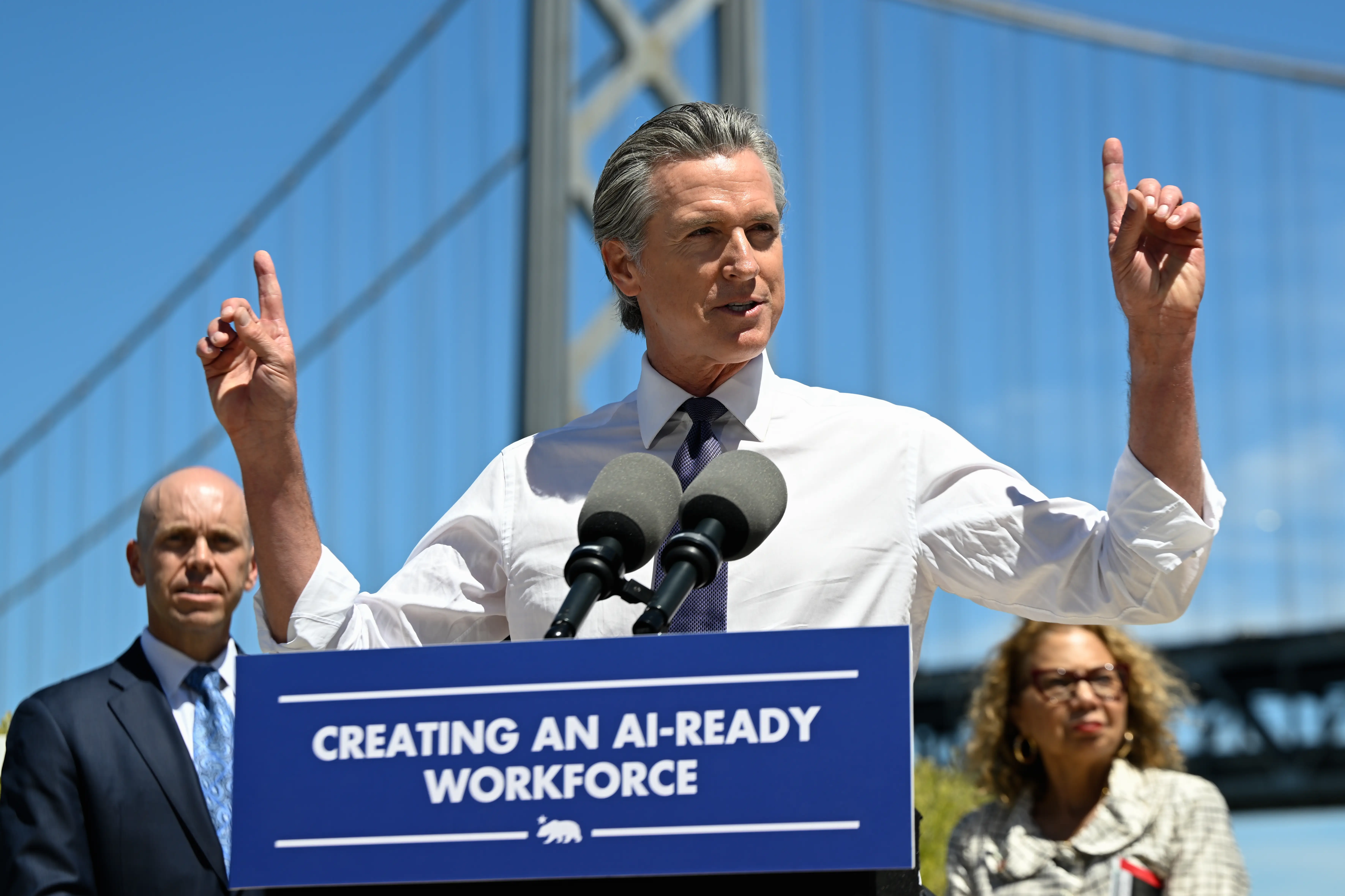 A man in a white shirt speaks.