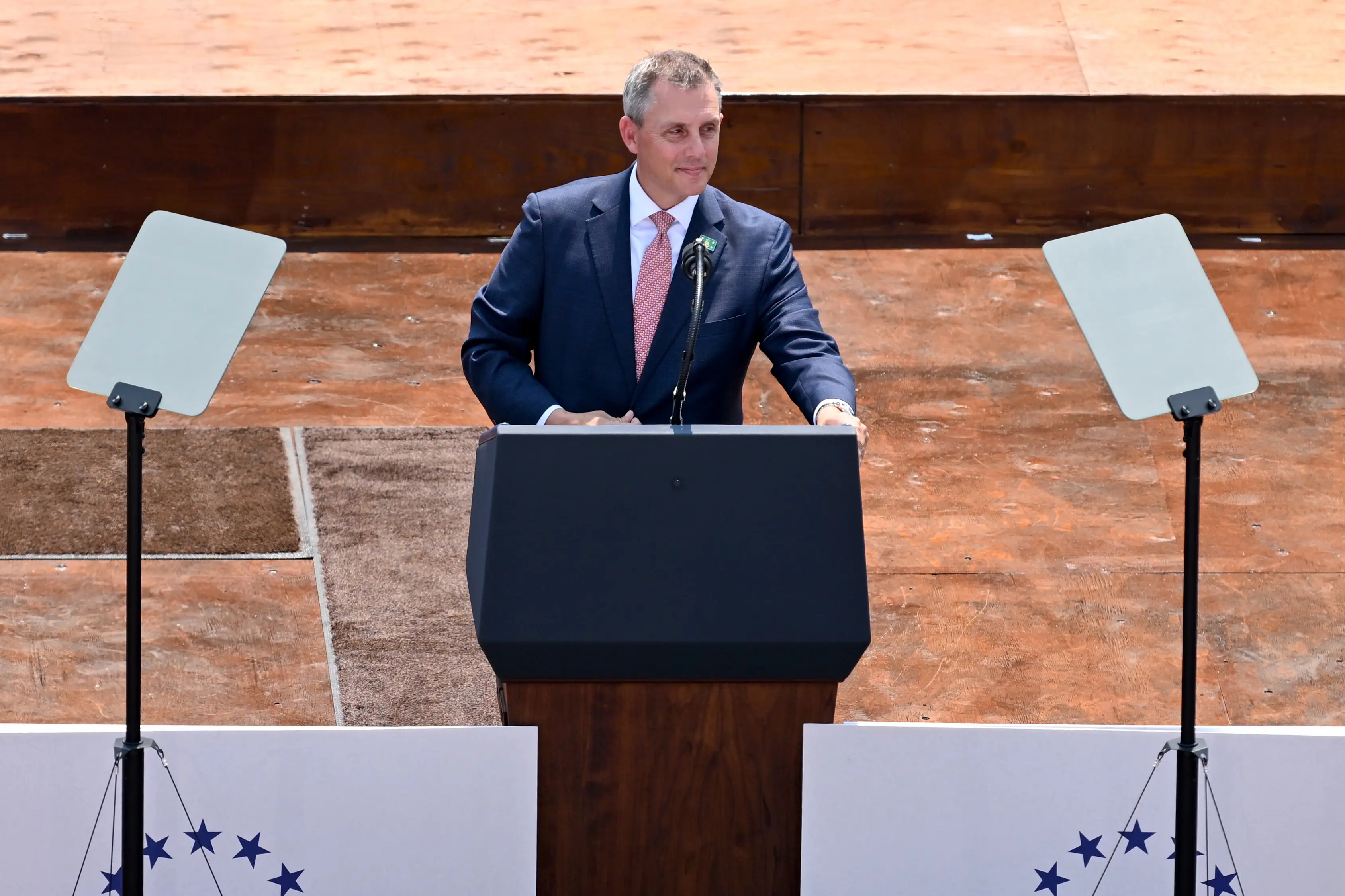 A man in a suit speaks.