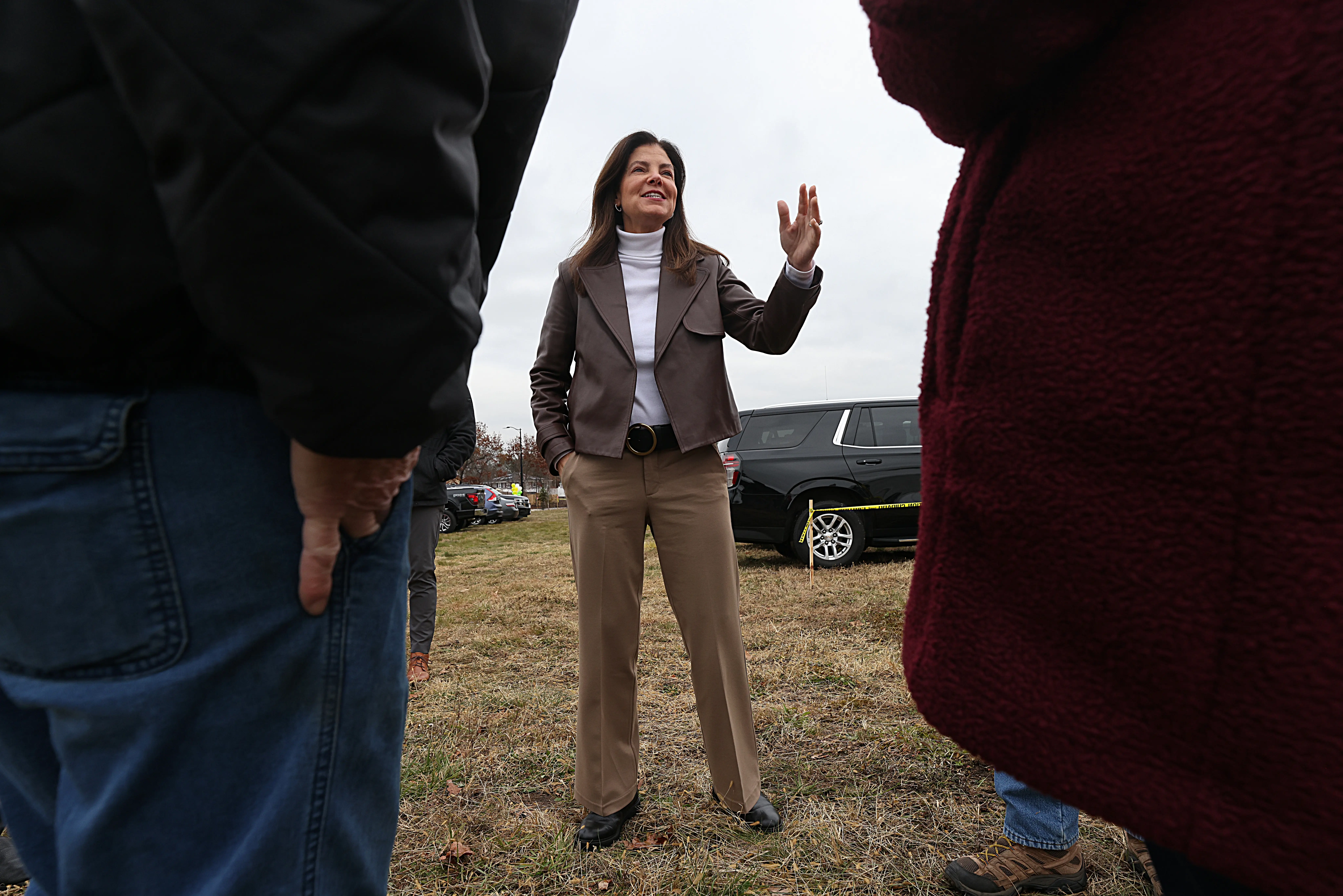 A woman in a suit speaks.