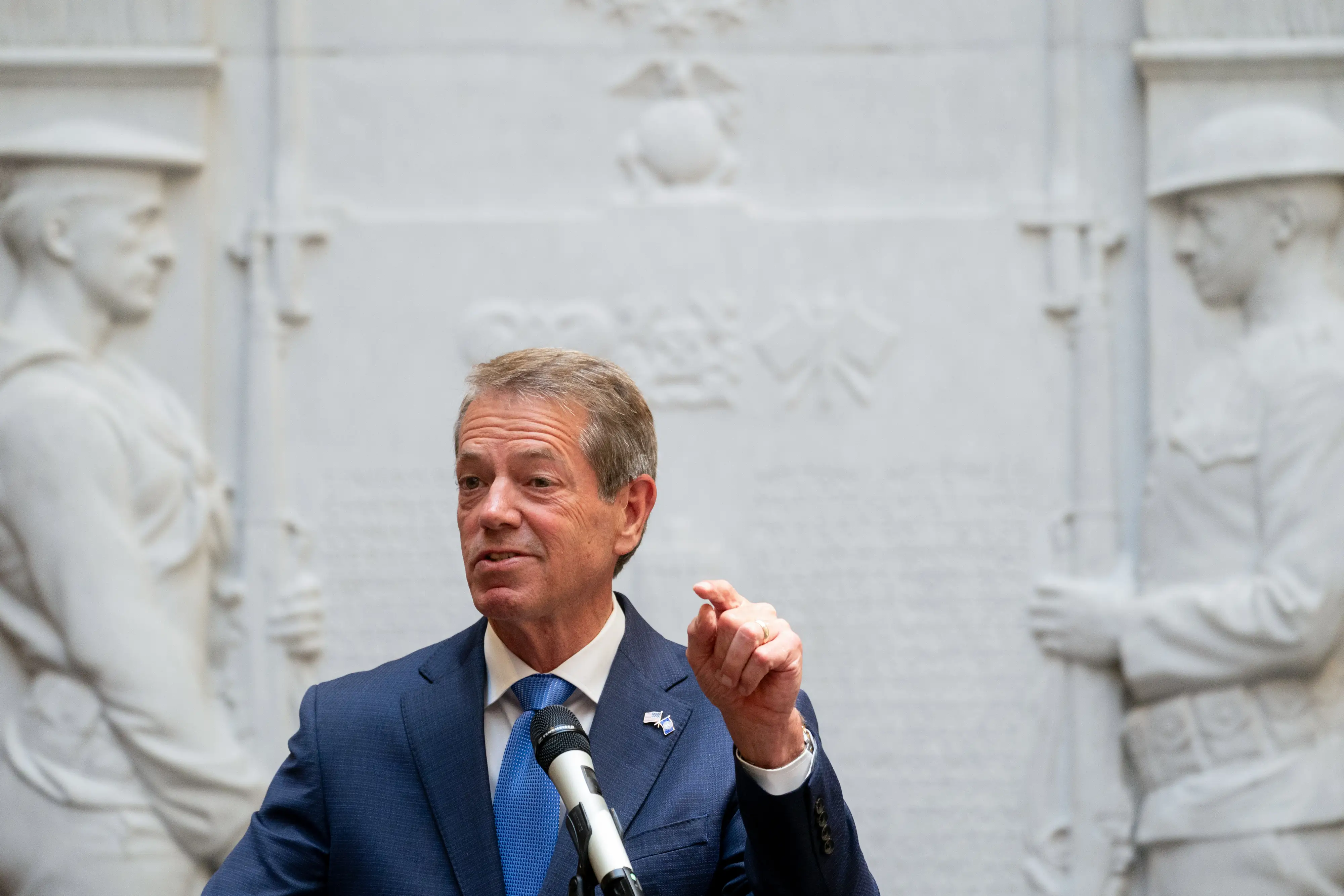 A man in a suit speaks.