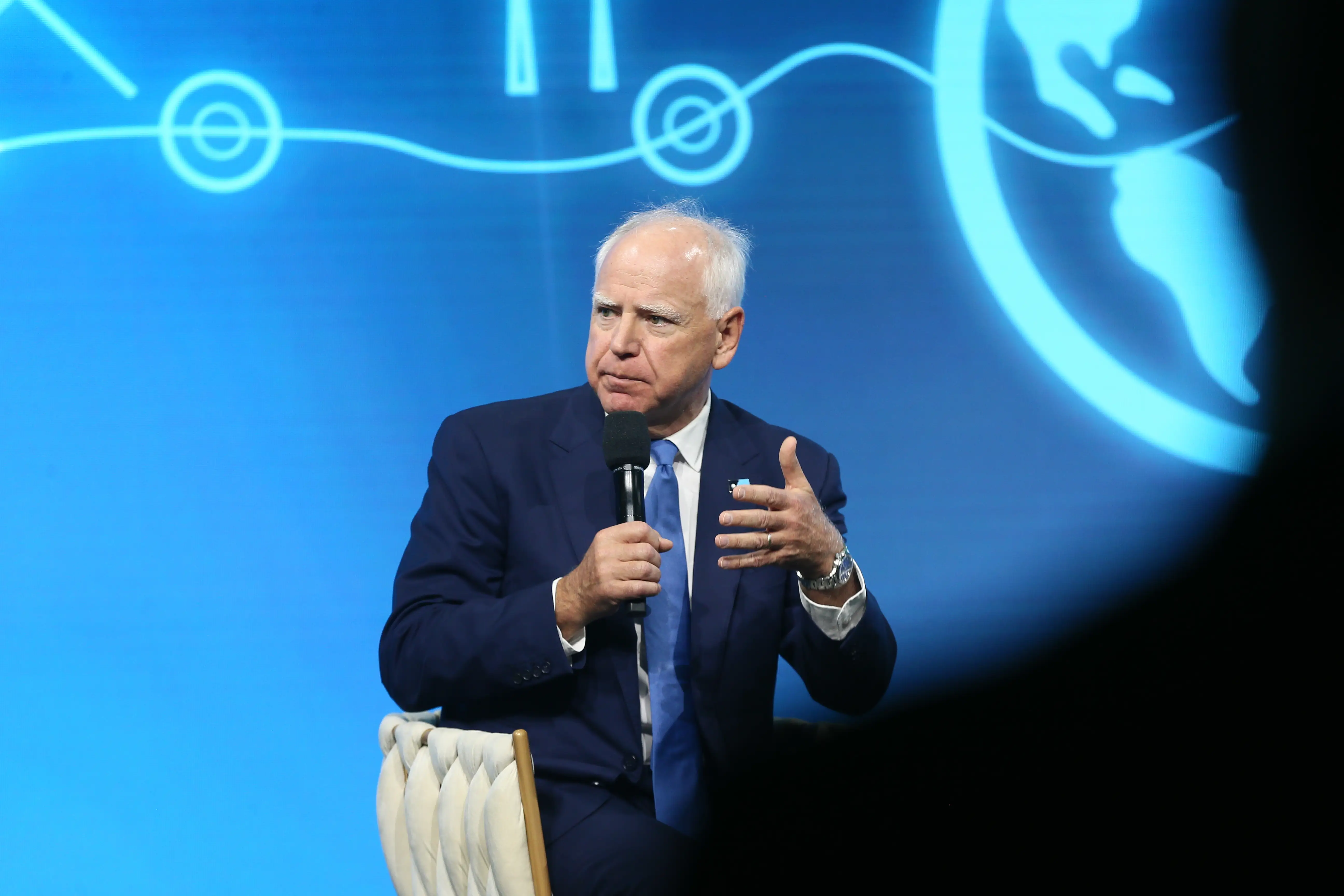 A man in a suit speaks.