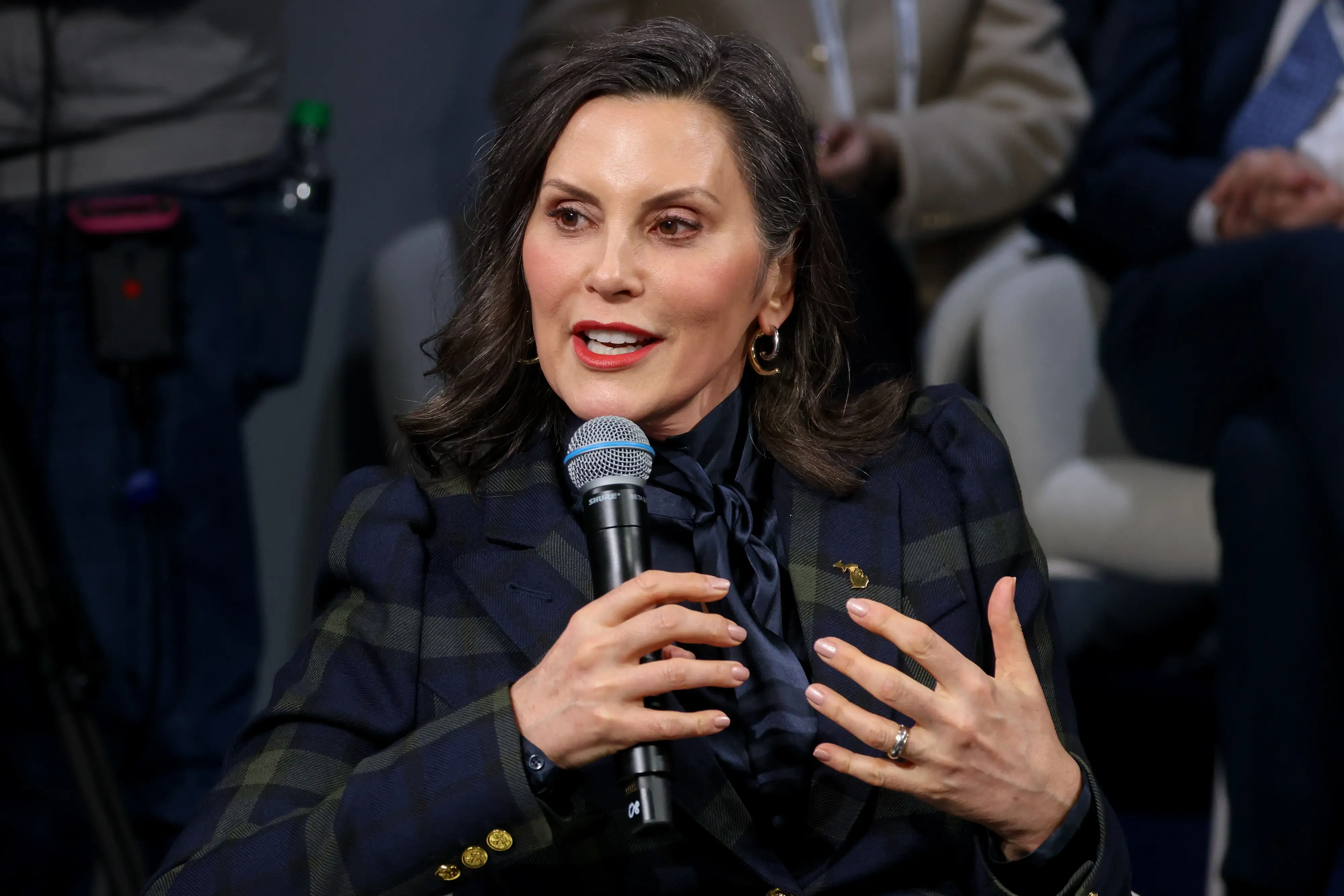 A woman in a suit speaks.