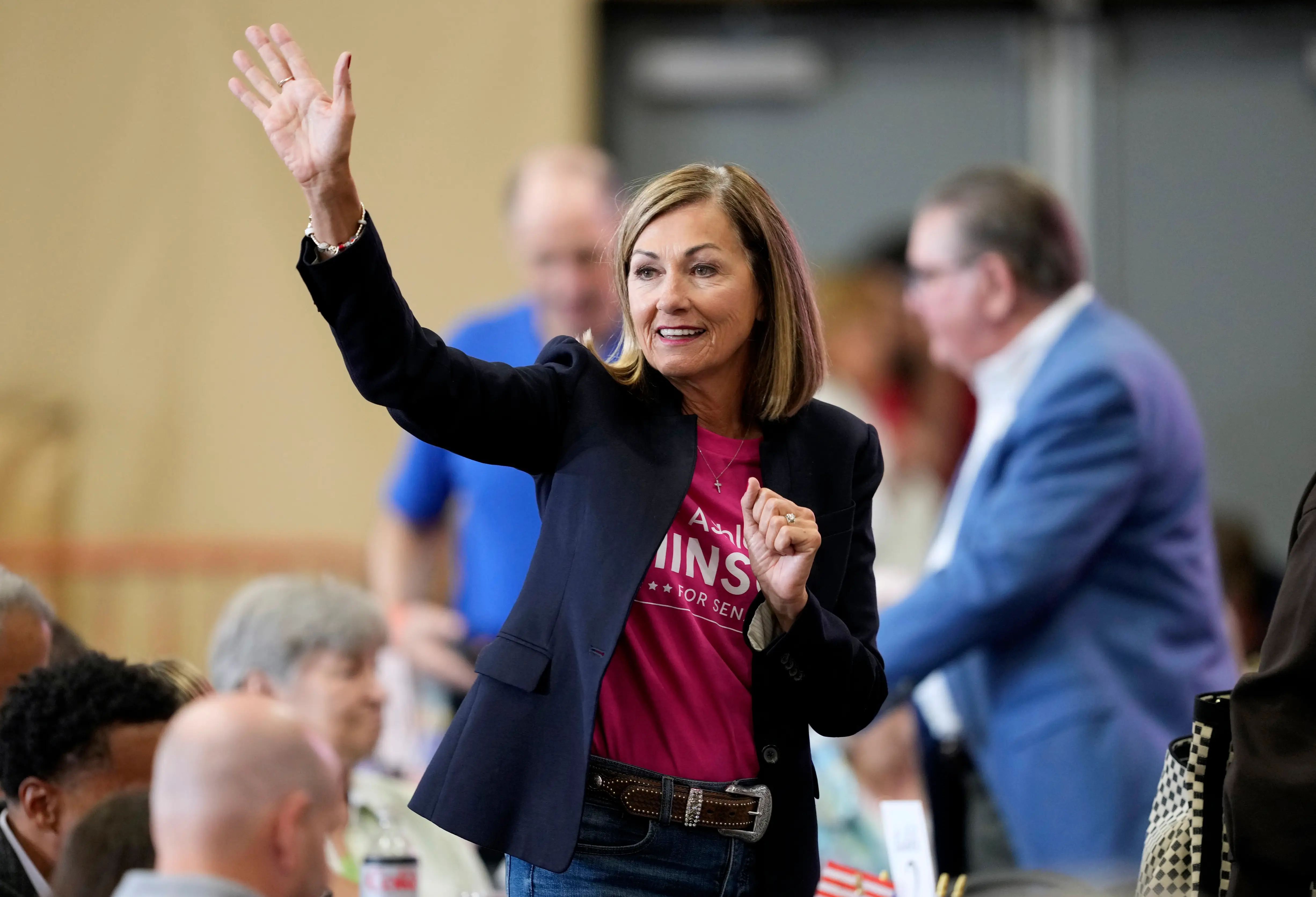 A woman waves.