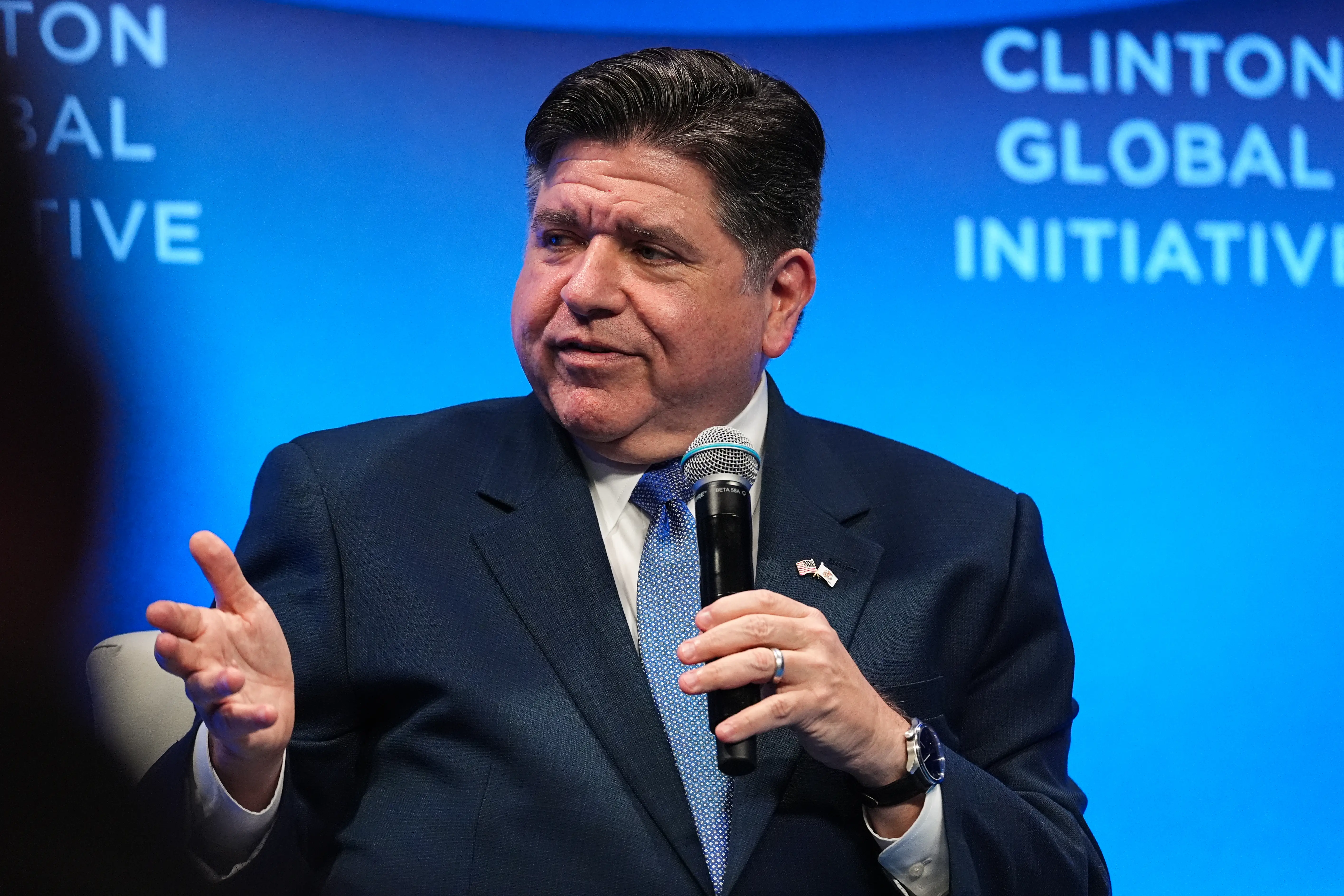 A man in a suit speaks.