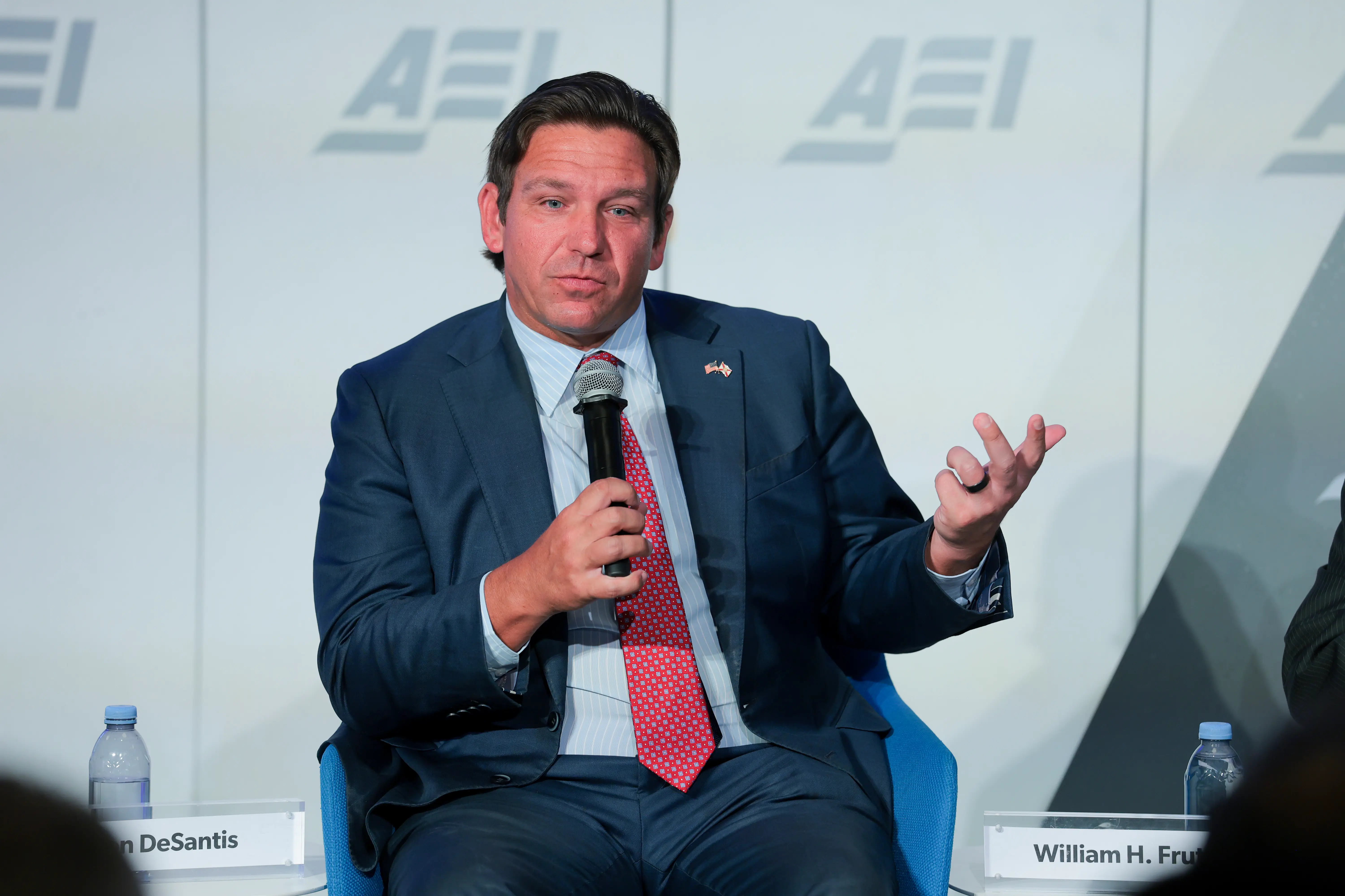 A man in a suit speaks.