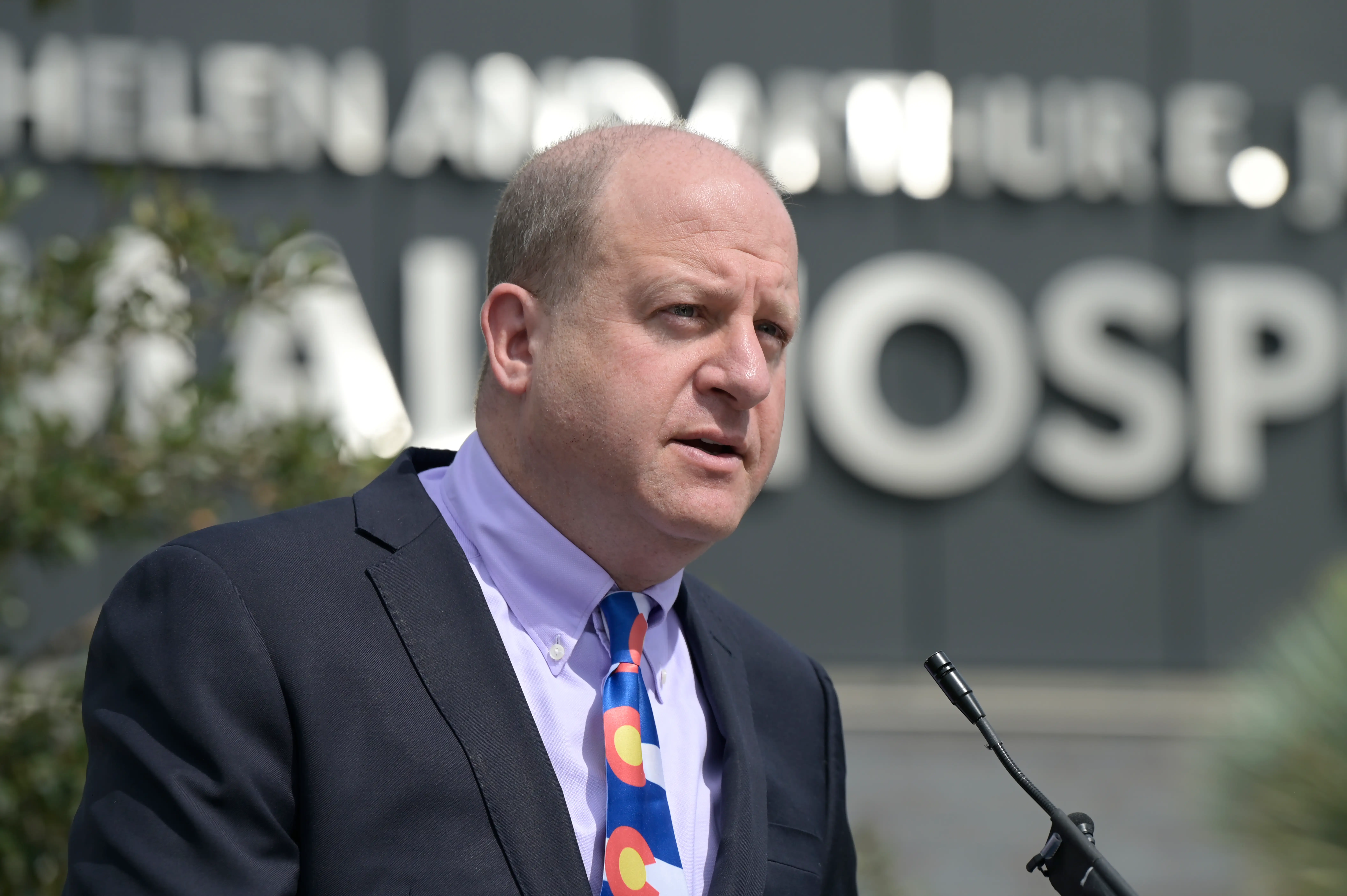 A man in a suit speaks.