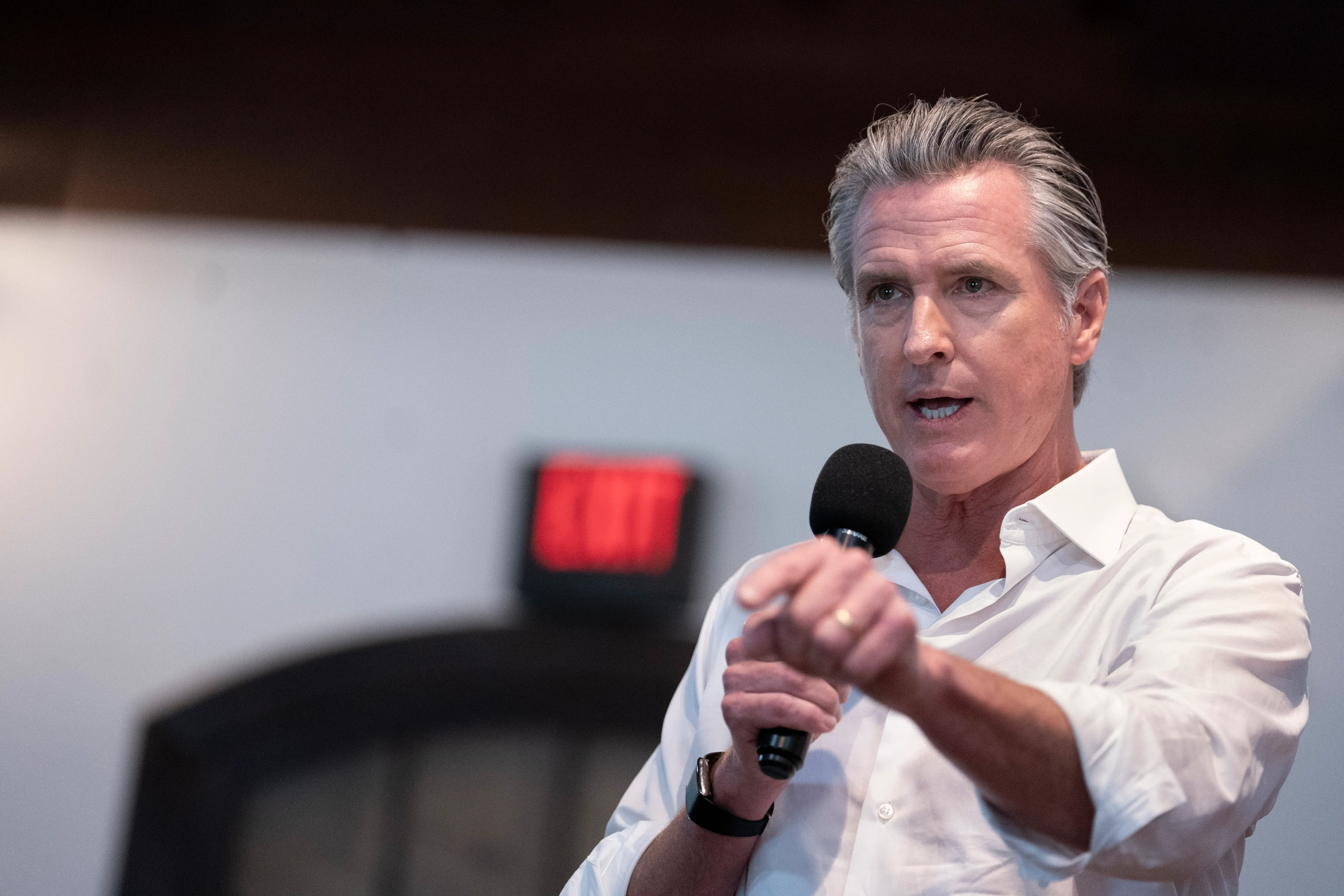 A man in a white shirt speaks.