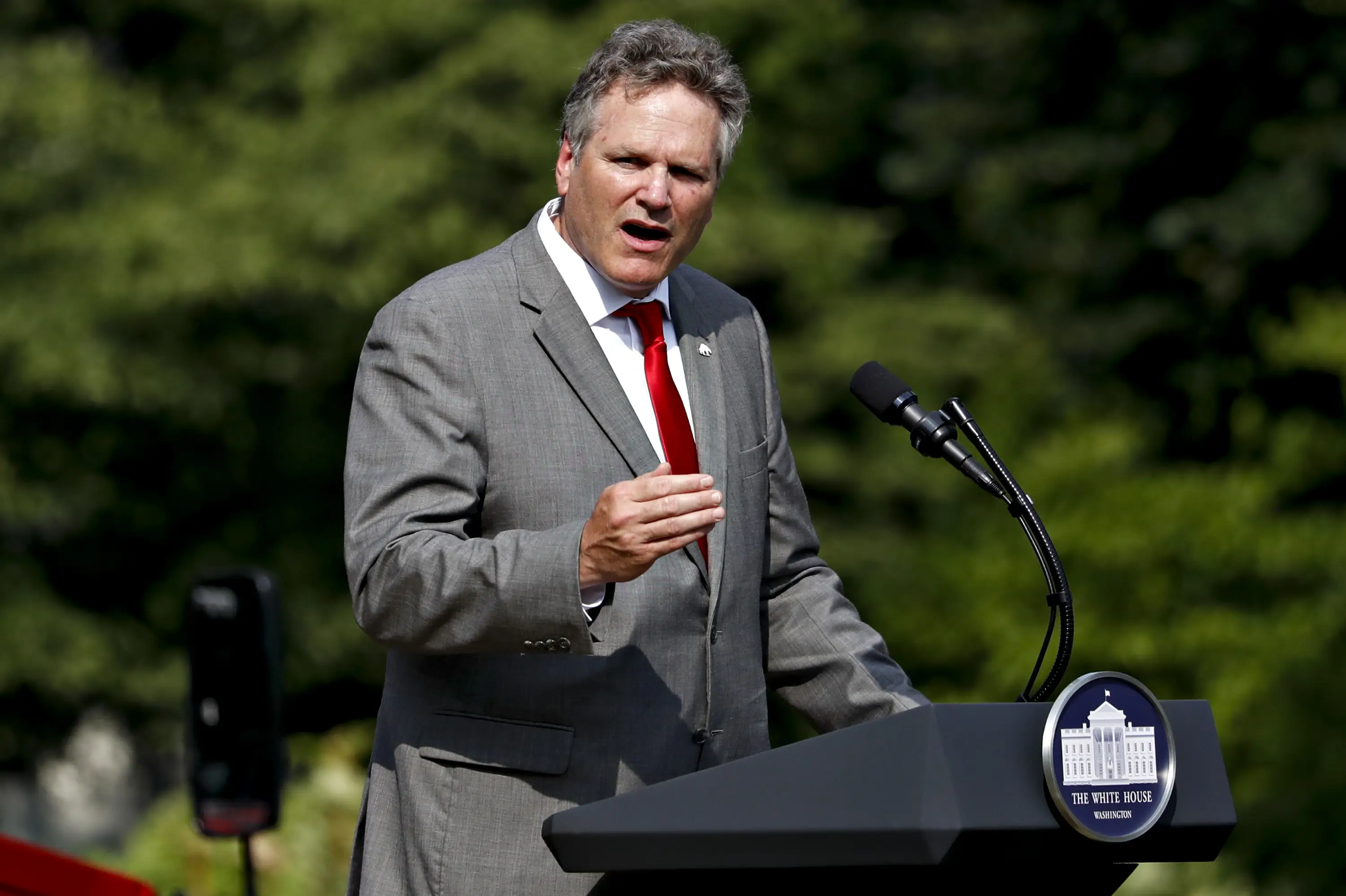 A man in a suit speaks.