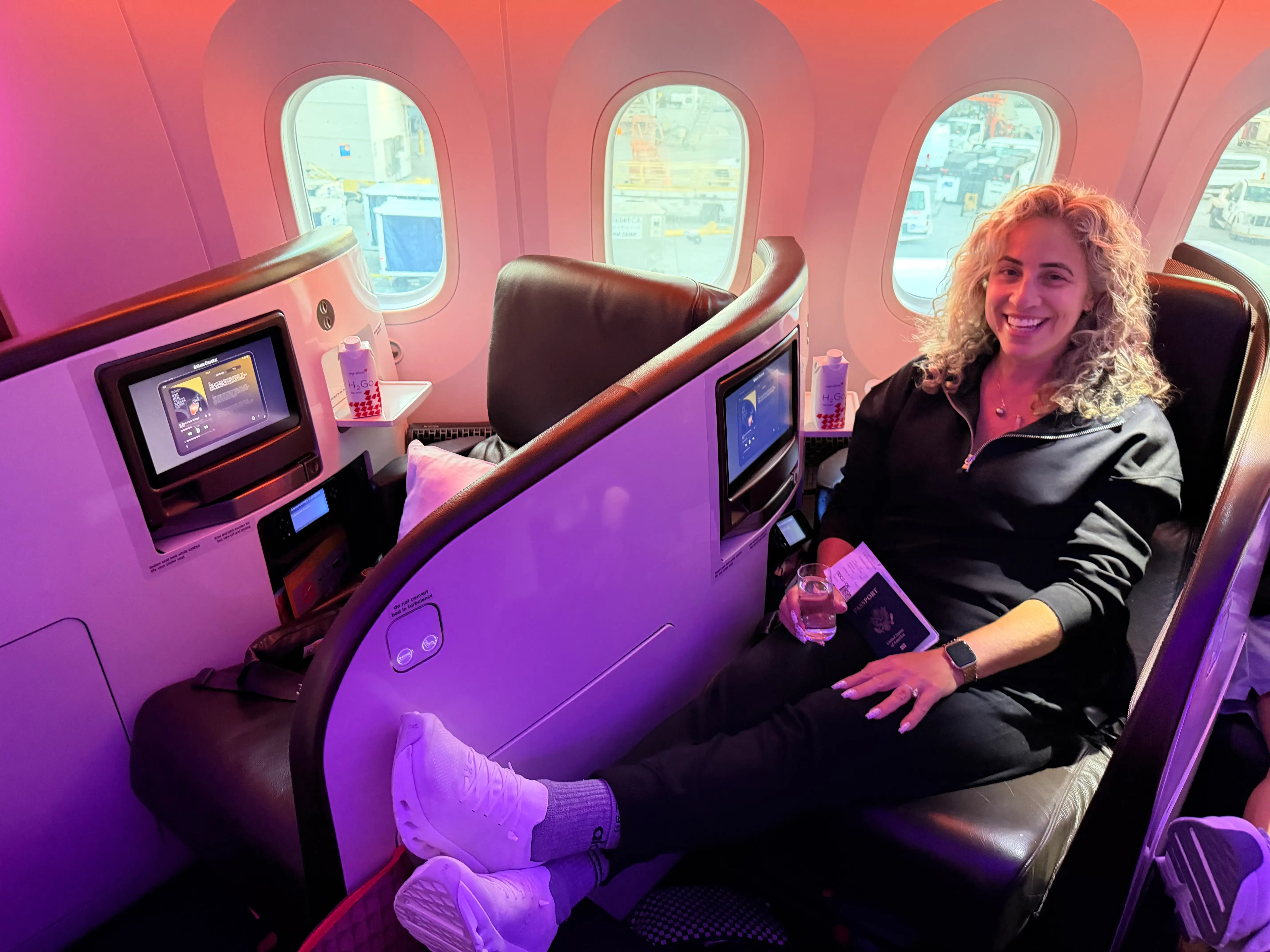 Woman sitting on seat on Virgin Atlantic upper class flight