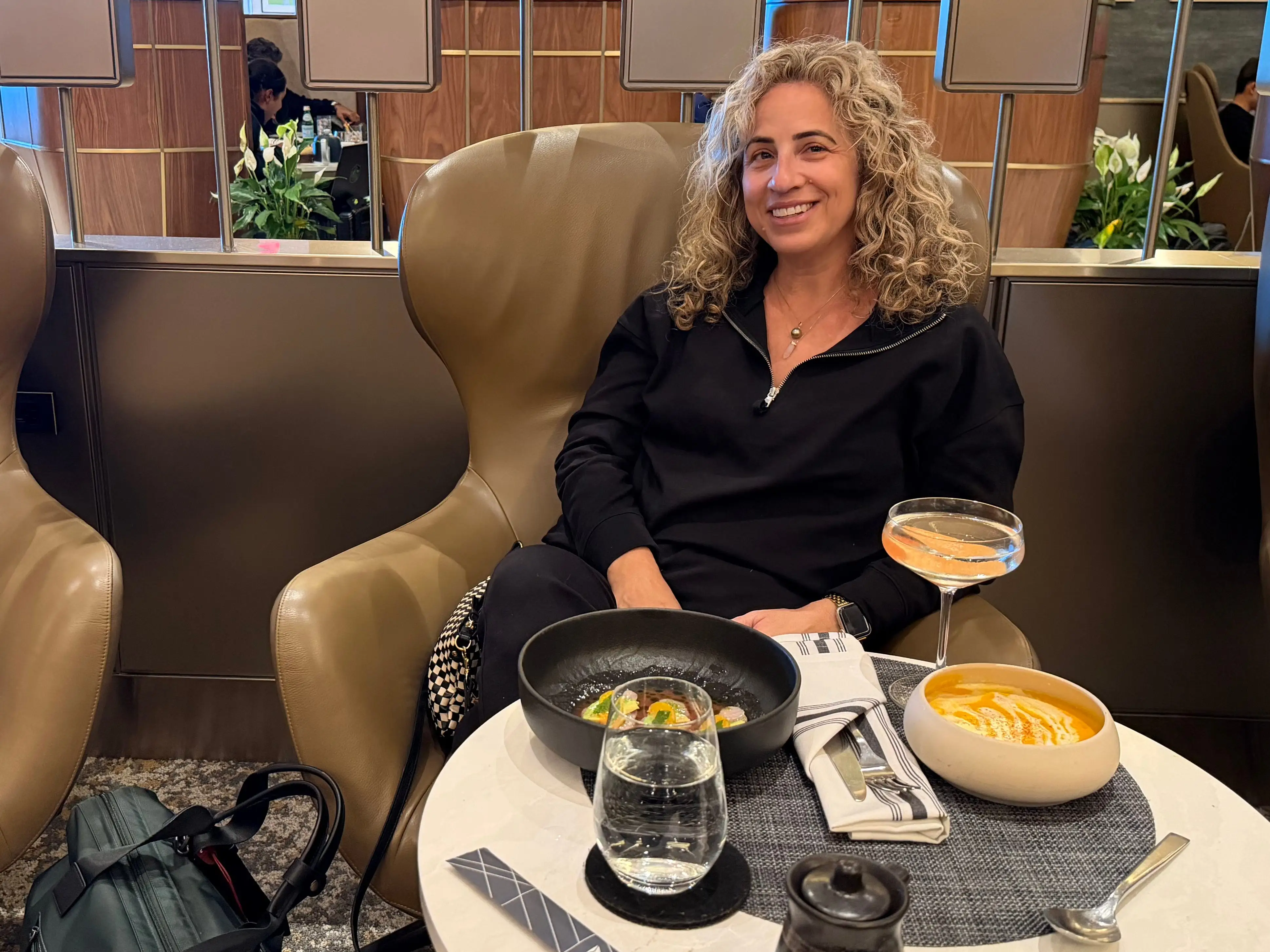 Woman sitting in Delta One Lounge in LAX