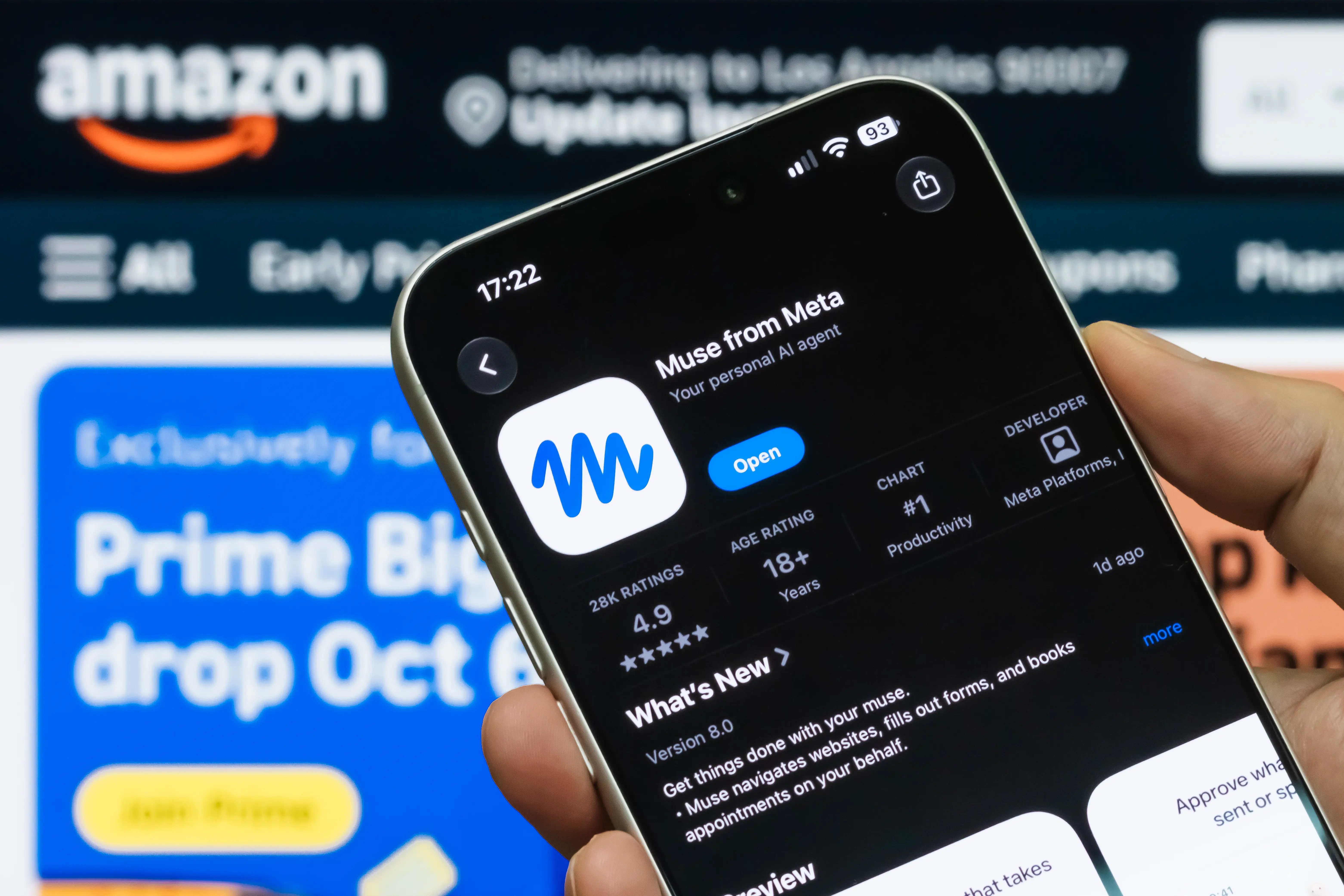 A smartphone displaying the App Store listing for Meta's Muse AI assistant in front of the Amazon website on a computer screen on September 22, 2026, in Shenzhen, Guangdong Province, China