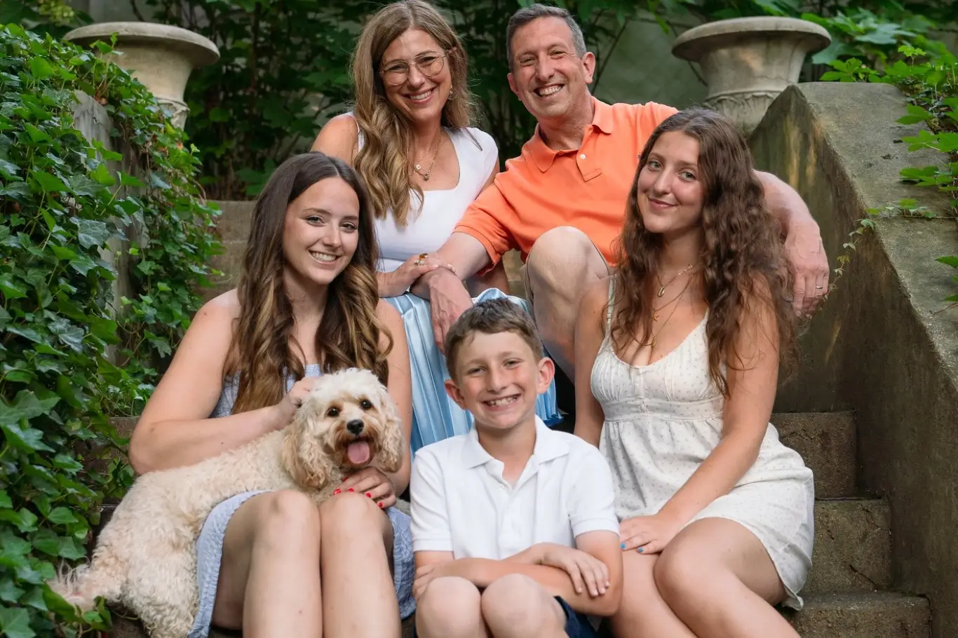 Family posing for photo with dog