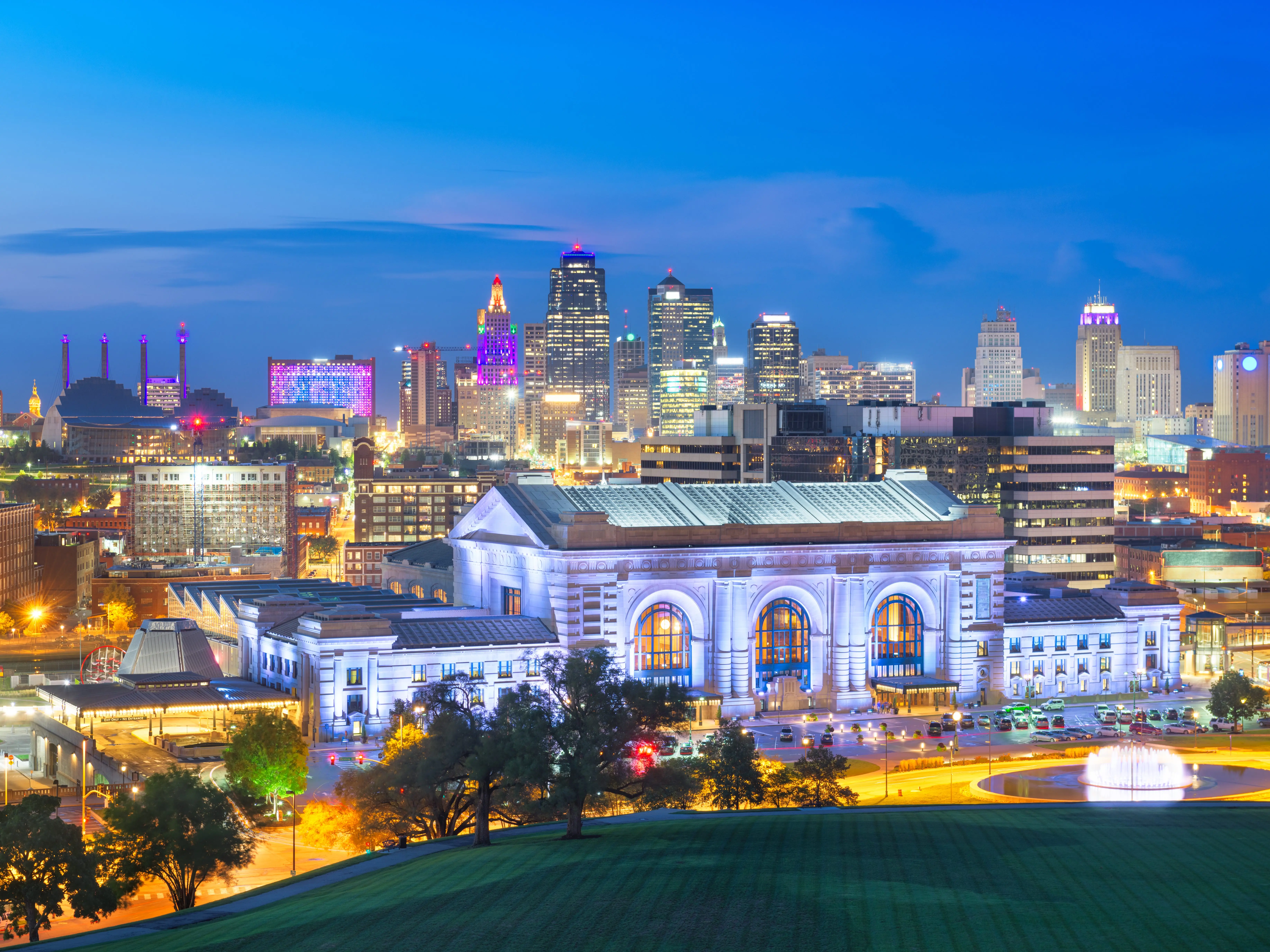 Kansas City, Missouri, USA downtown skyline with Union Station at blue hour.