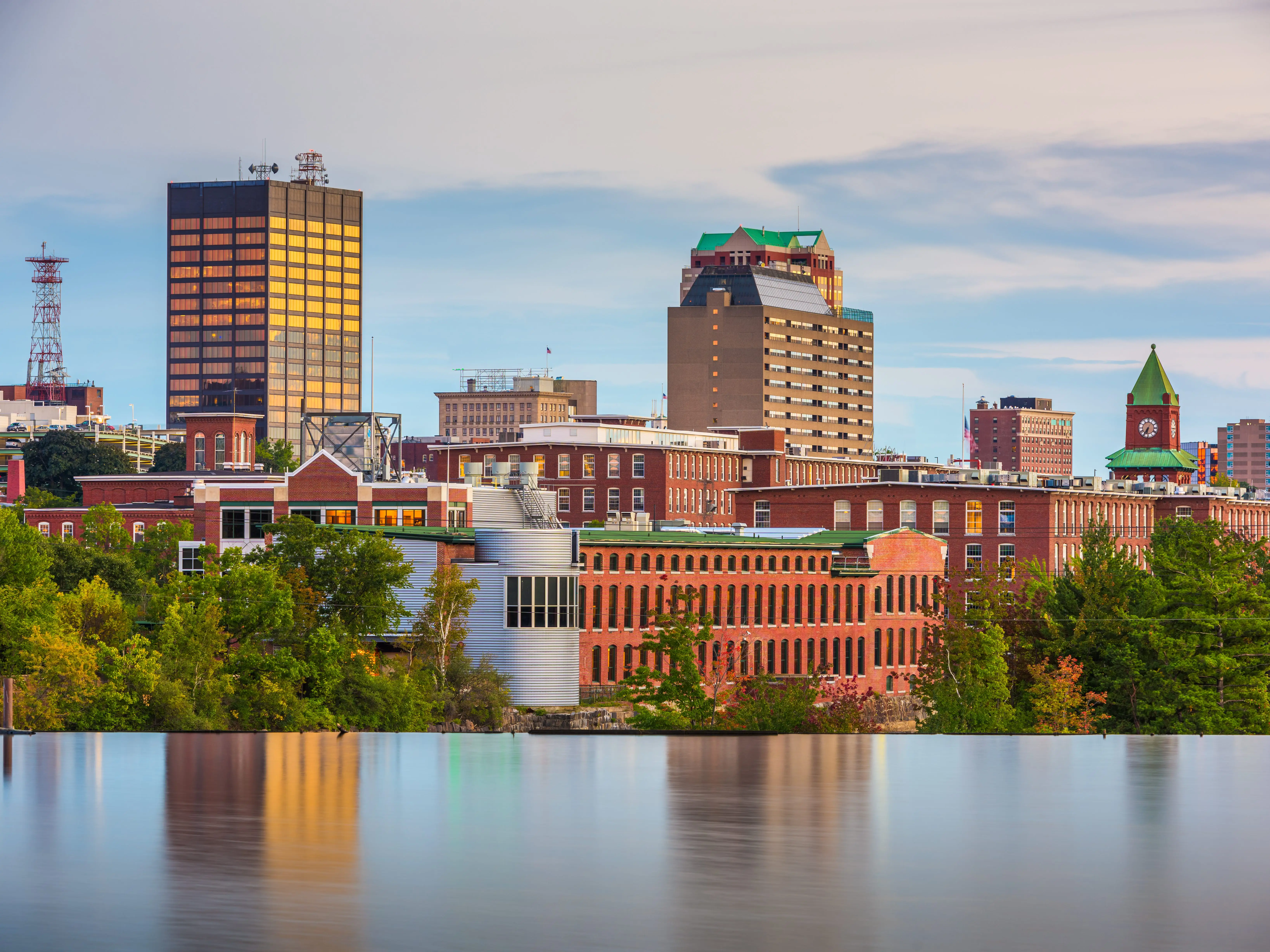Manchester, New Hampshire, USA Skyline on the Merrimack River at dusk.