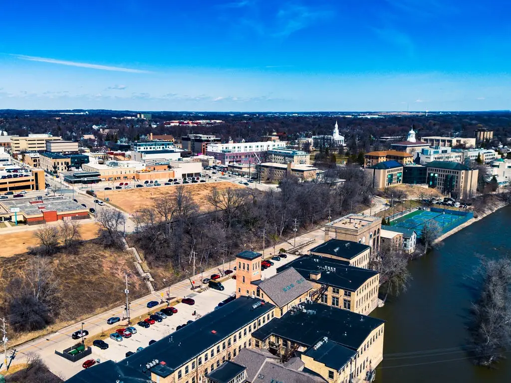 Aerial Photograph of Appleton Wisconsin downtown with the Fox River passing through the lower part of the frame on a partly cloudy day.