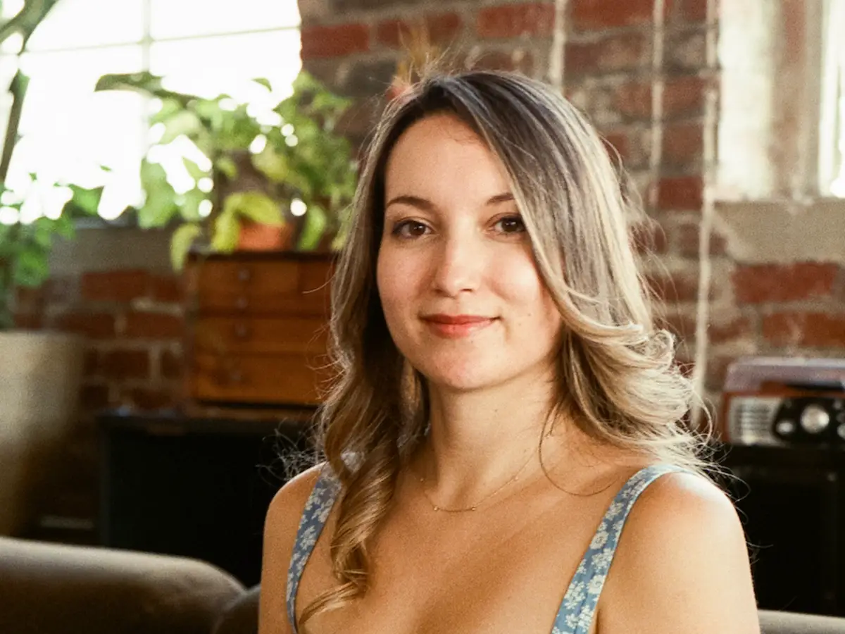 head shot of a woman in a floral top