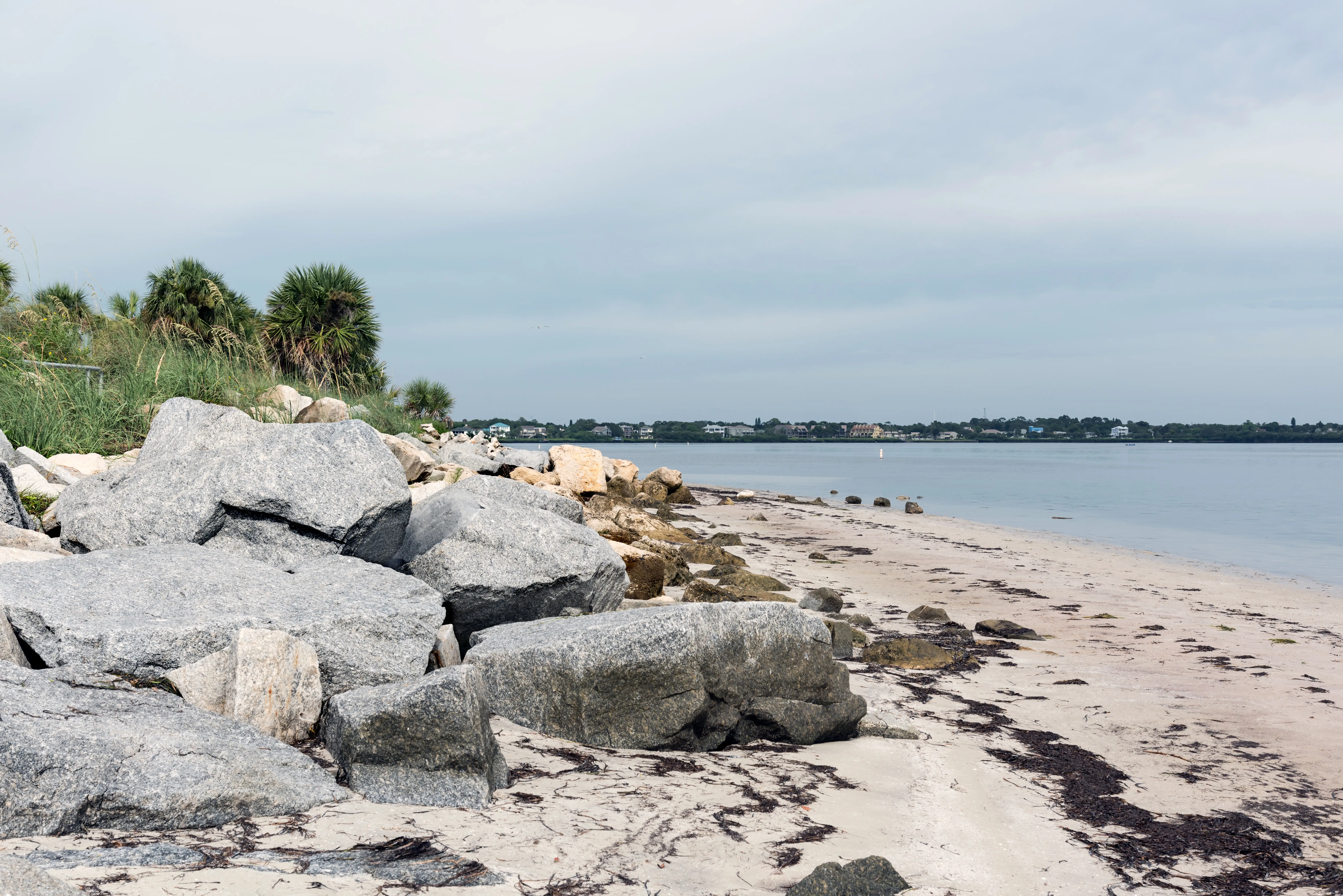 Huge boulders on the shore of the Gulf of Mexico in Fred Howard Park, Florida, USA.