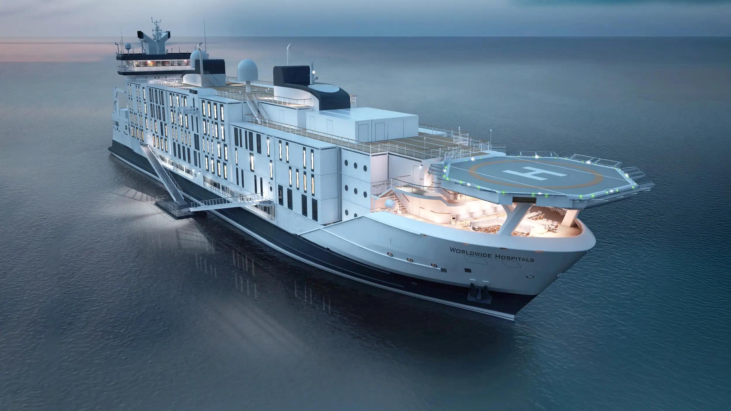 Large hospital ship with illuminated decks and a helipad floats on calm open water at dusk.