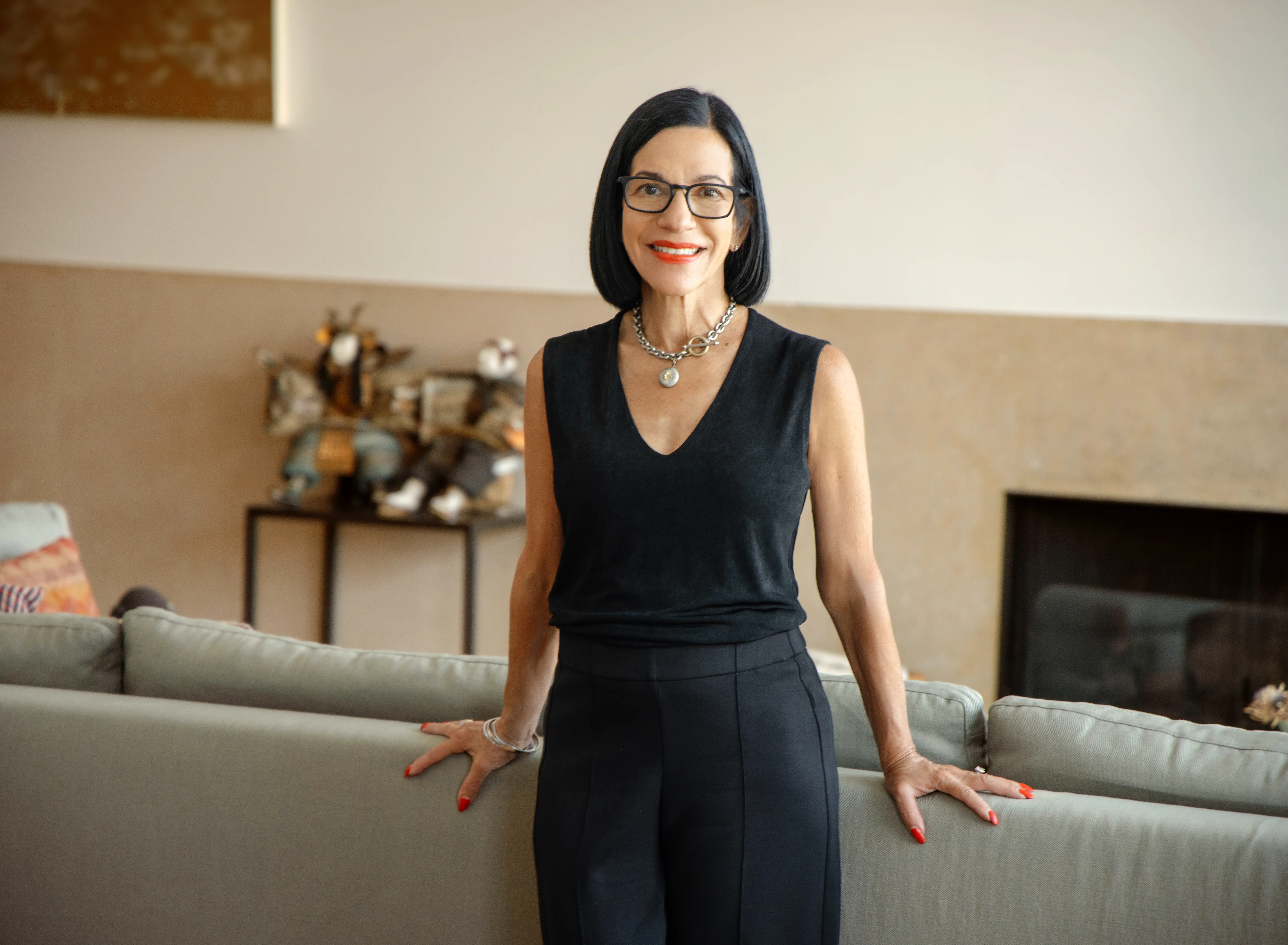 Brigitte Weil standing against a couch.